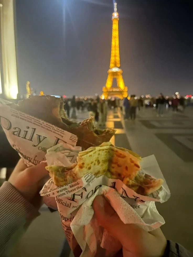 Crepes at night in front of the lit up Eiffel Tower in Paris, France
