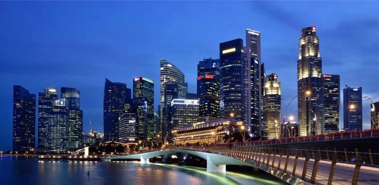 Singapore city skyline at night with bright lights