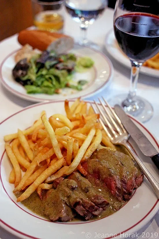 Steak-Frites dinner with red wine in Paris, France