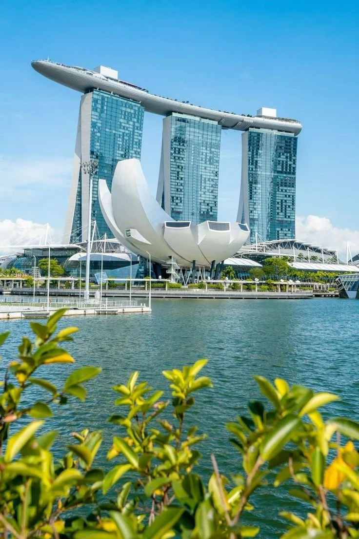 Marina Bay Sands towers and Artscience museum in daylight by the water