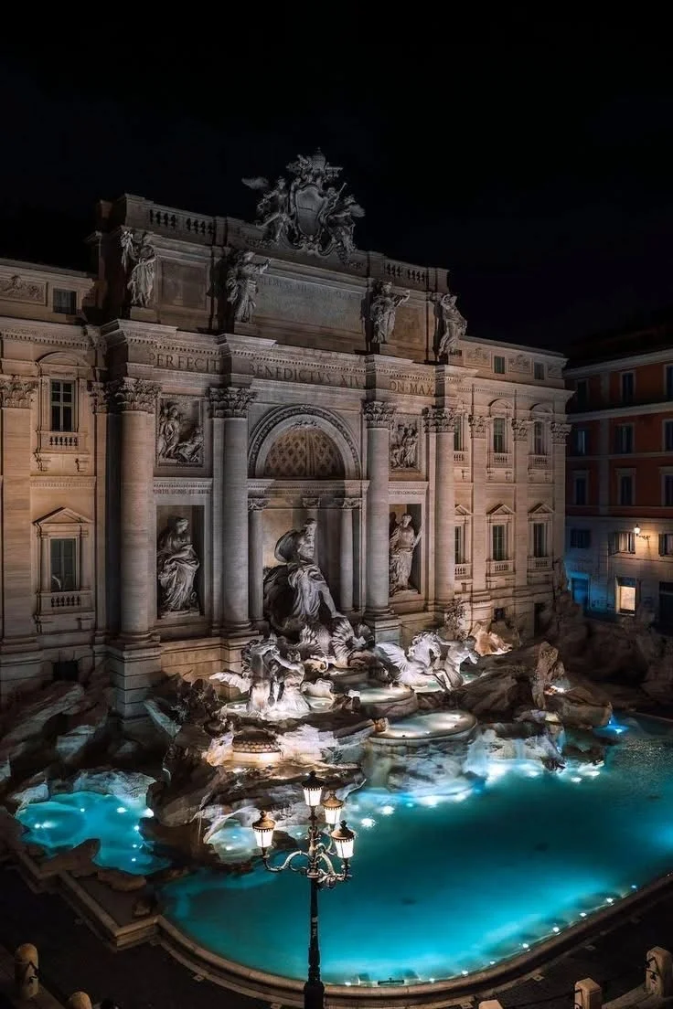 up-top view of the Trevi Fountain at night in Rome, Italy