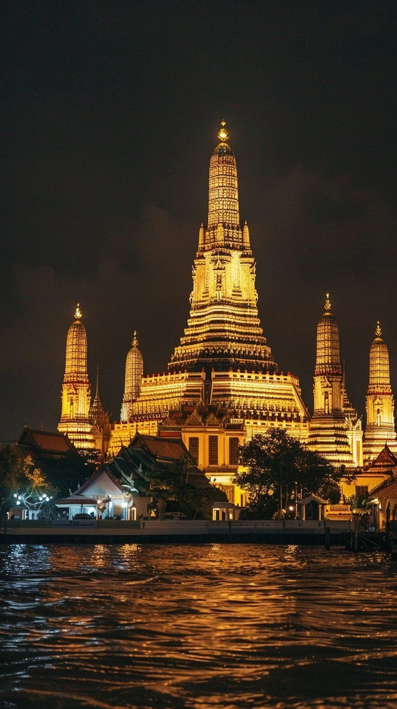 Illuminated temple or palace at night reflected on water.