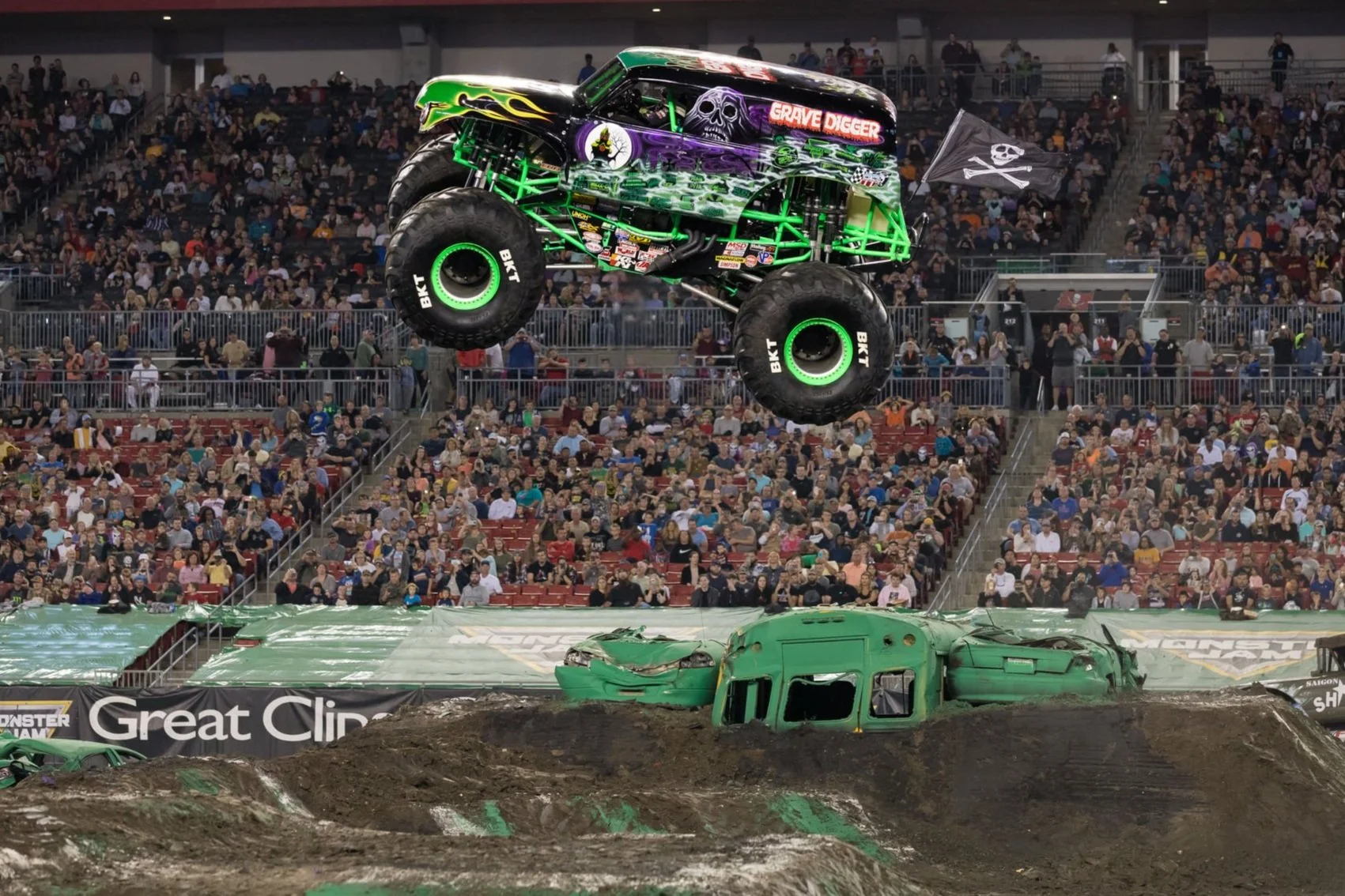 Crackerjack Media entertainment marketing at Raymond James Stadium in Tampa — Grave Digger monster truck soaring during Monster Jam.