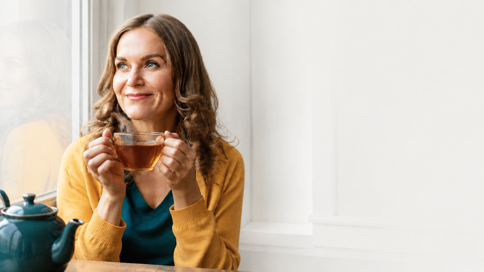 Susan Hovey, Founder of SMASH Marketing & Success Coaching drinking a cup of tea contentedly