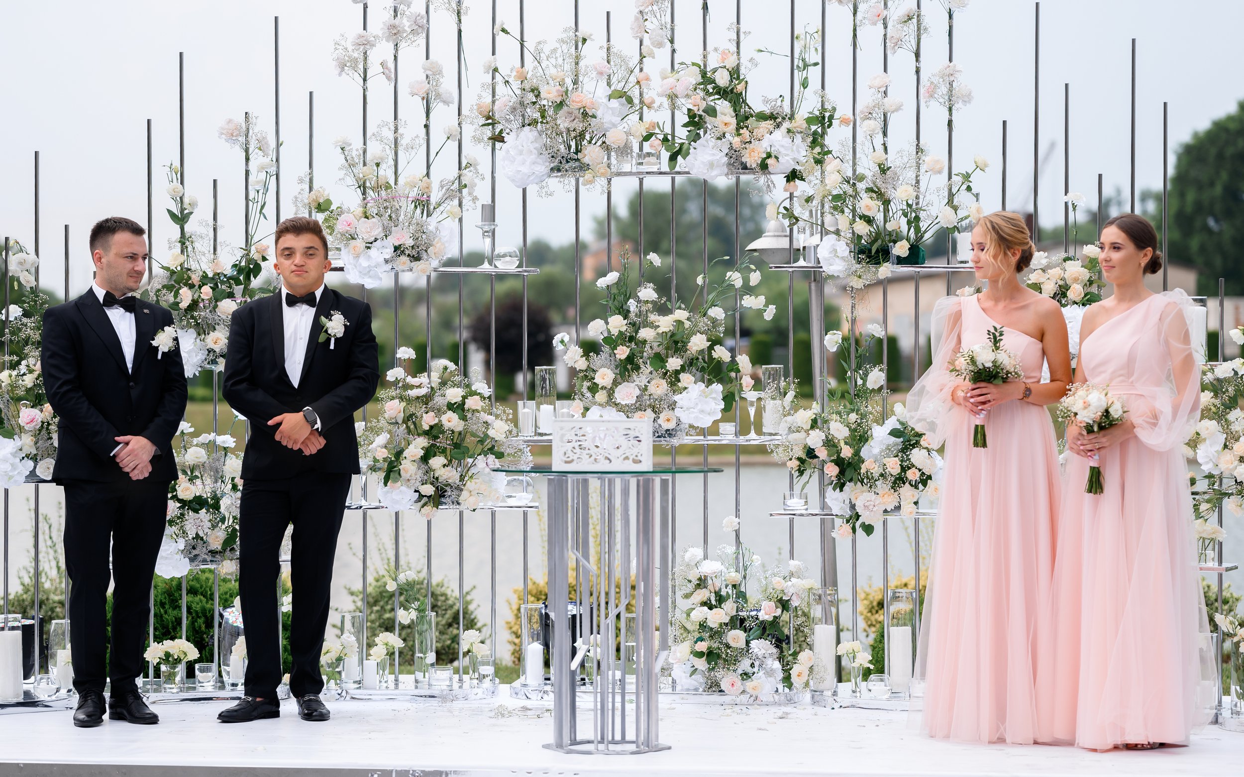 happy-frieds-brides-near-wedding-decorative-arch.jpg