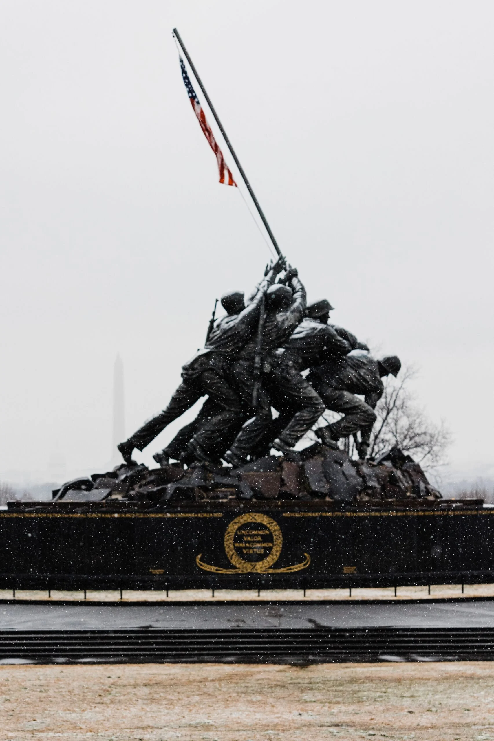 The Iwo Jima Marine Corps War Memorial, a bronze sculpture of soldiers raising the American flag during World War II, captured on a snowy day.