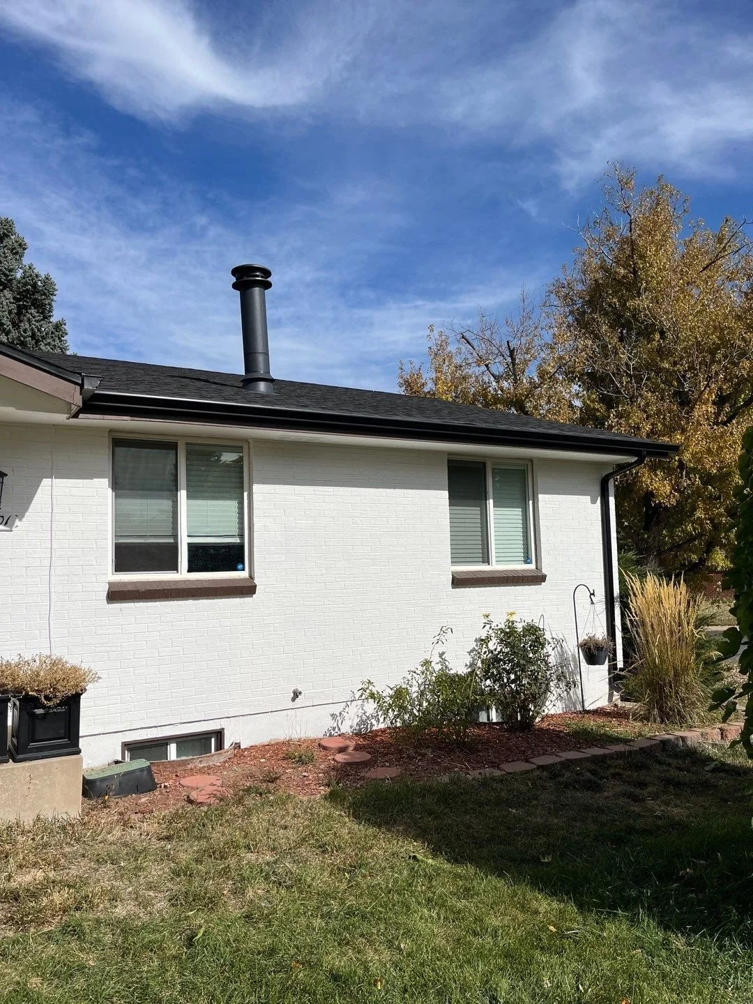 Complete gutter replacement fitted along the side of a single-story home with a low-slope roof.