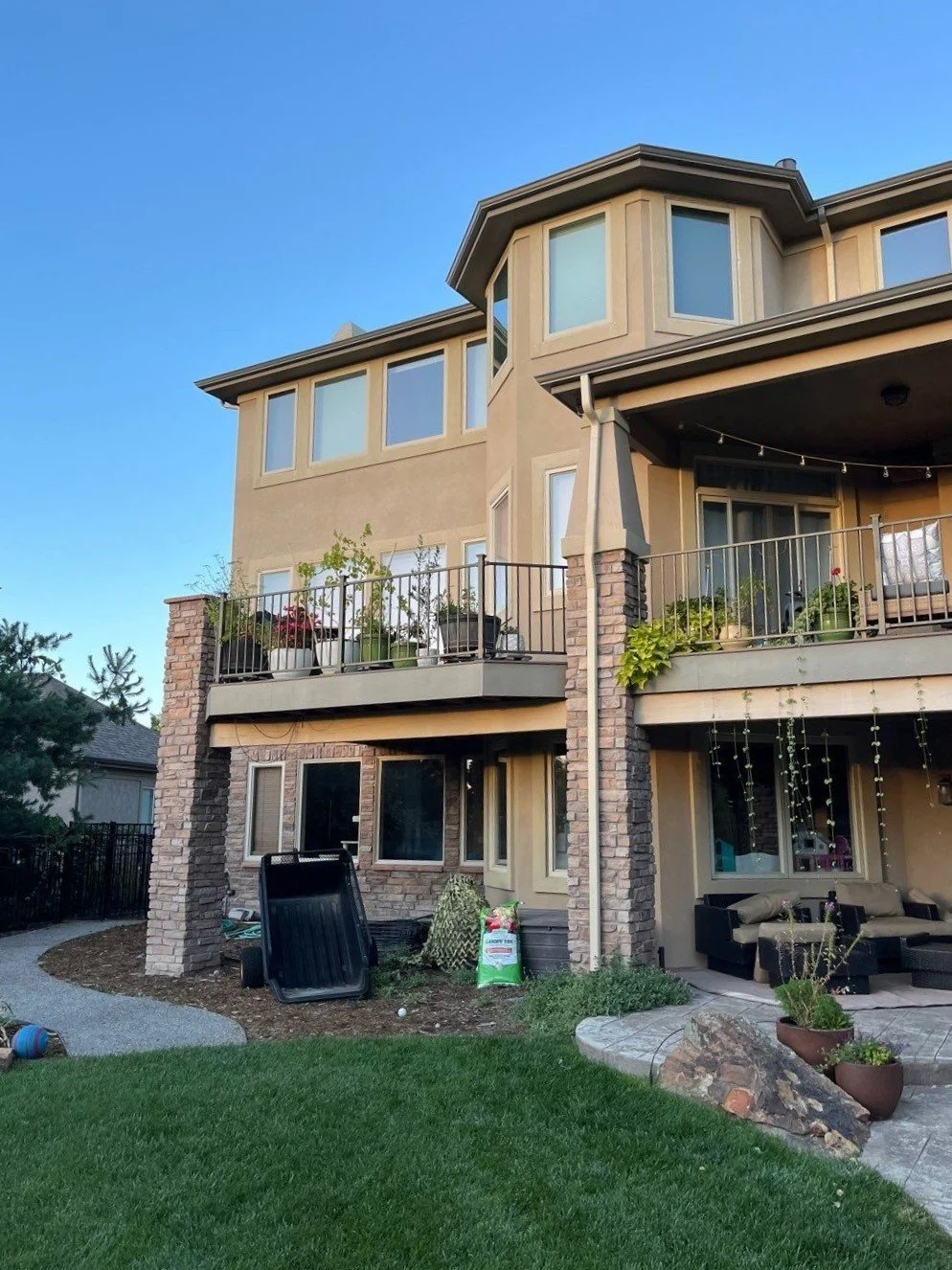 Complete gutter replacement installed around the rear decks and multiple rooflines of a large two-story home.