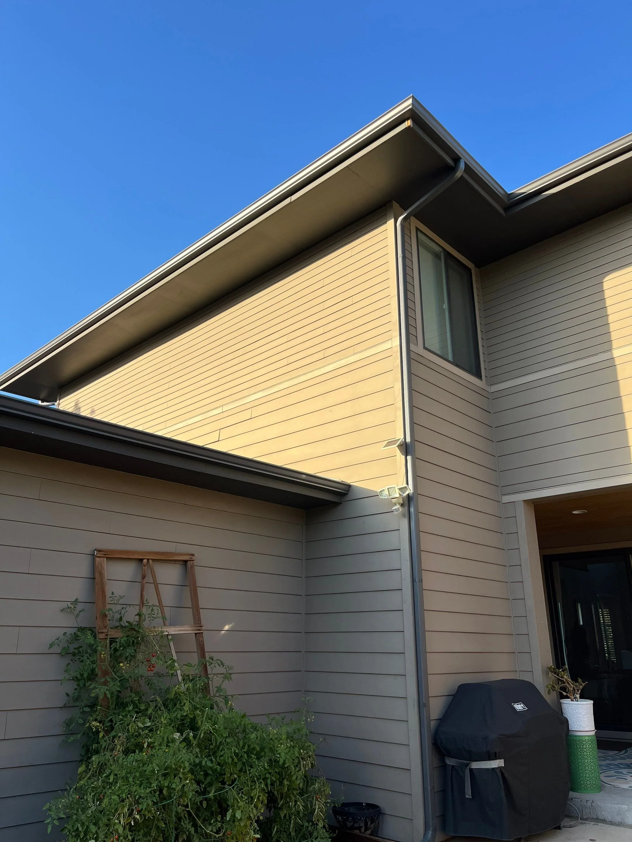 Seamless gutter installed along the upper roofline of a two-story home.