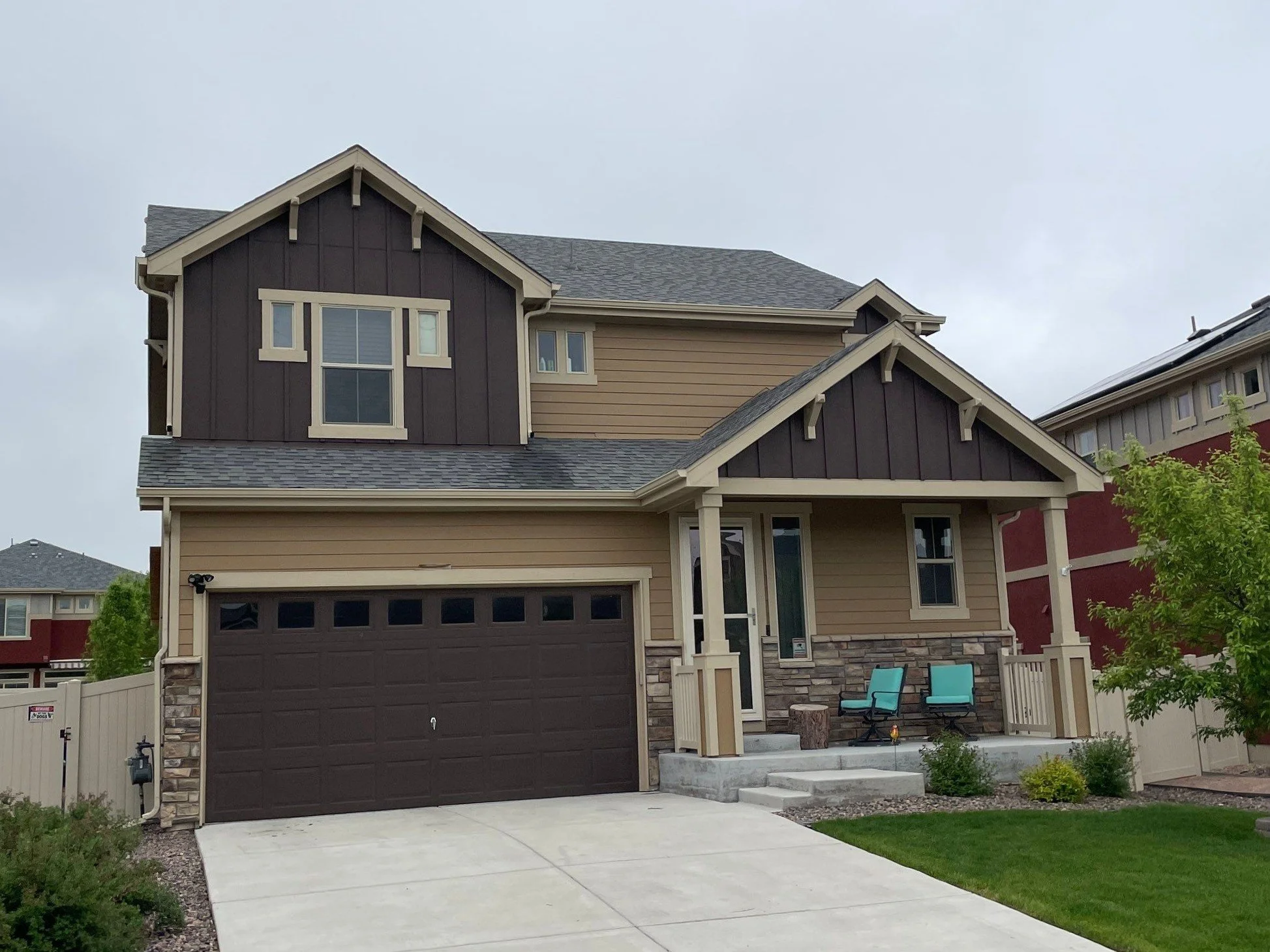 Residential gutter installation completed on a two-story home with multiple rooflines and an attached garage.