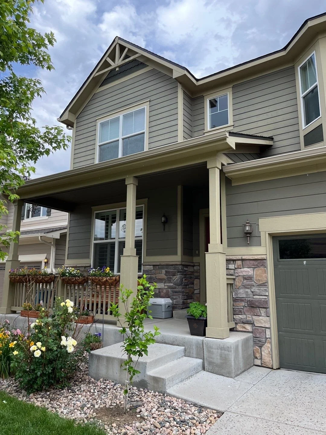 Seamless gutter replacement with new gutters and downspouts installed around the covered front porch and garage.