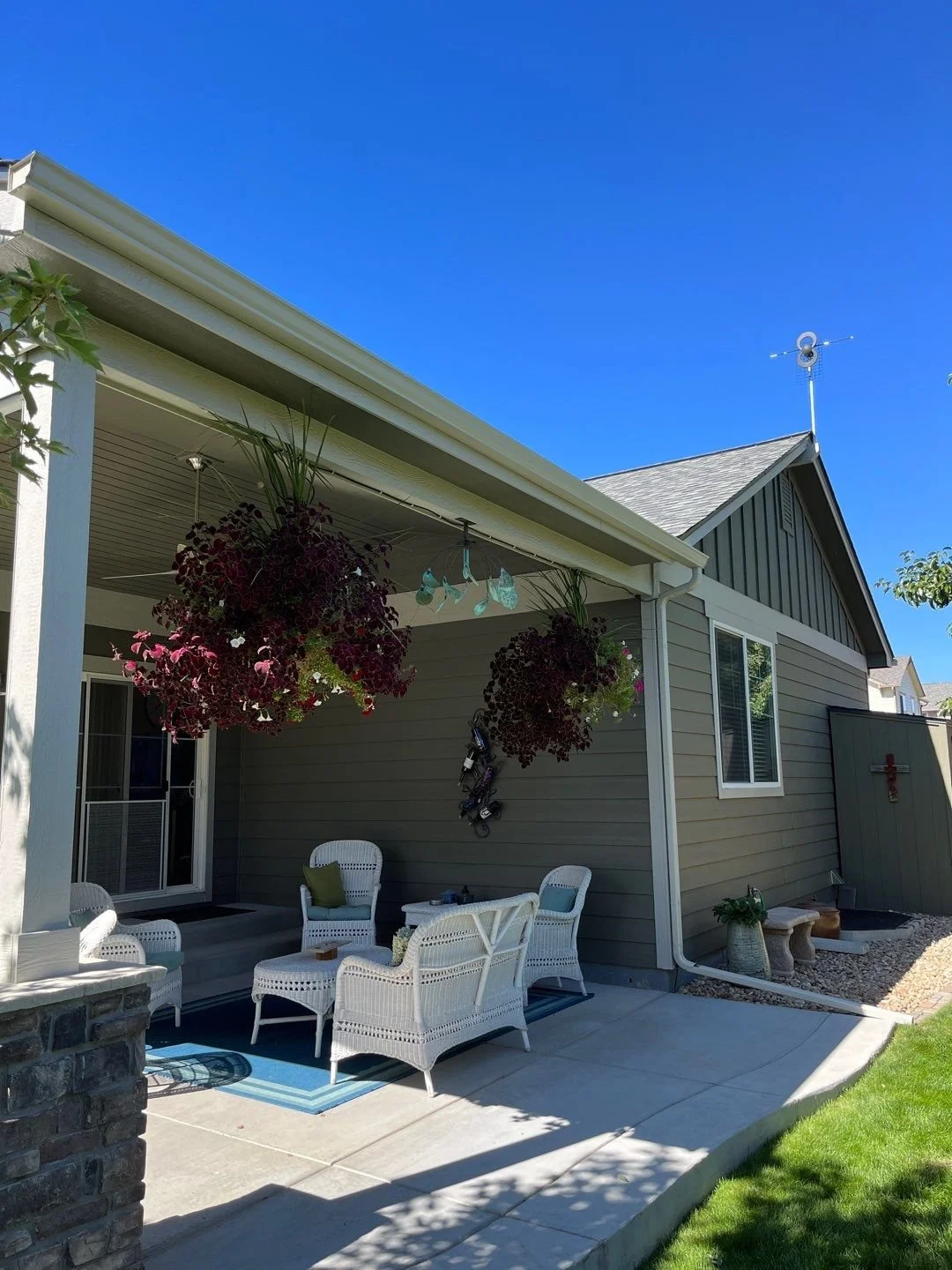 Custom seamless gutter installation added around a covered backyard patio to manage runoff and protect the outdoor living area.