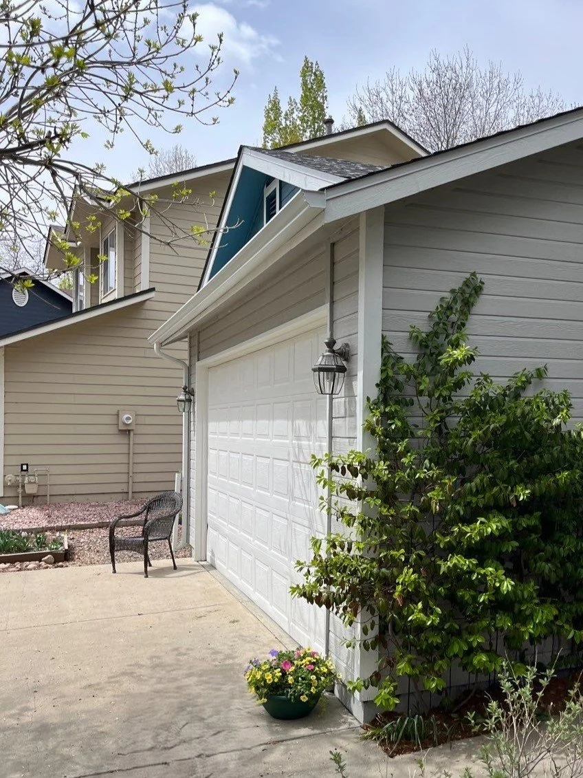 Seamless gutter replacement with new gutters and downspouts installed along the side roofline of a one story home