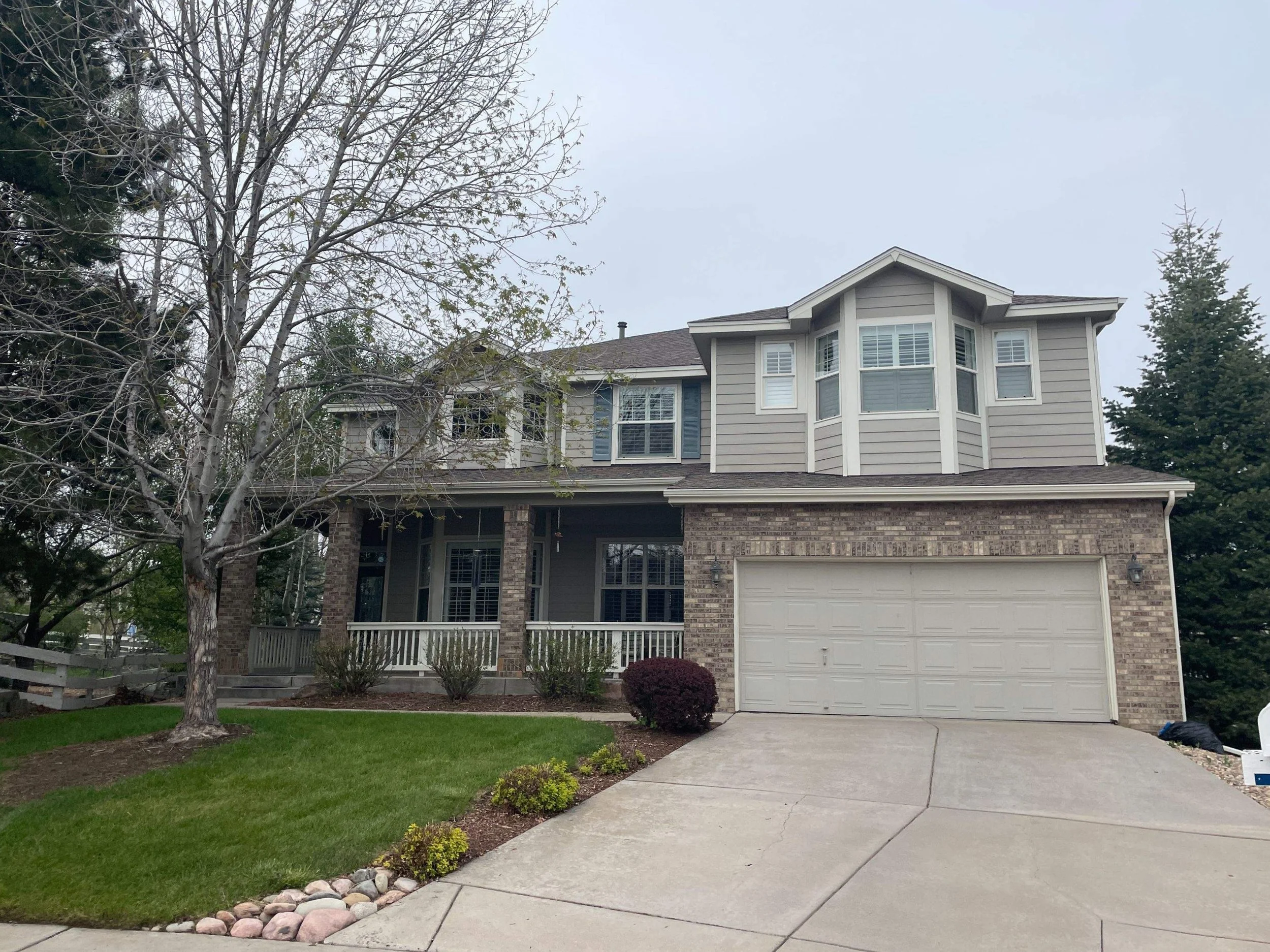 Completed seamless gutter installation across the front rooflines of a two-story home.