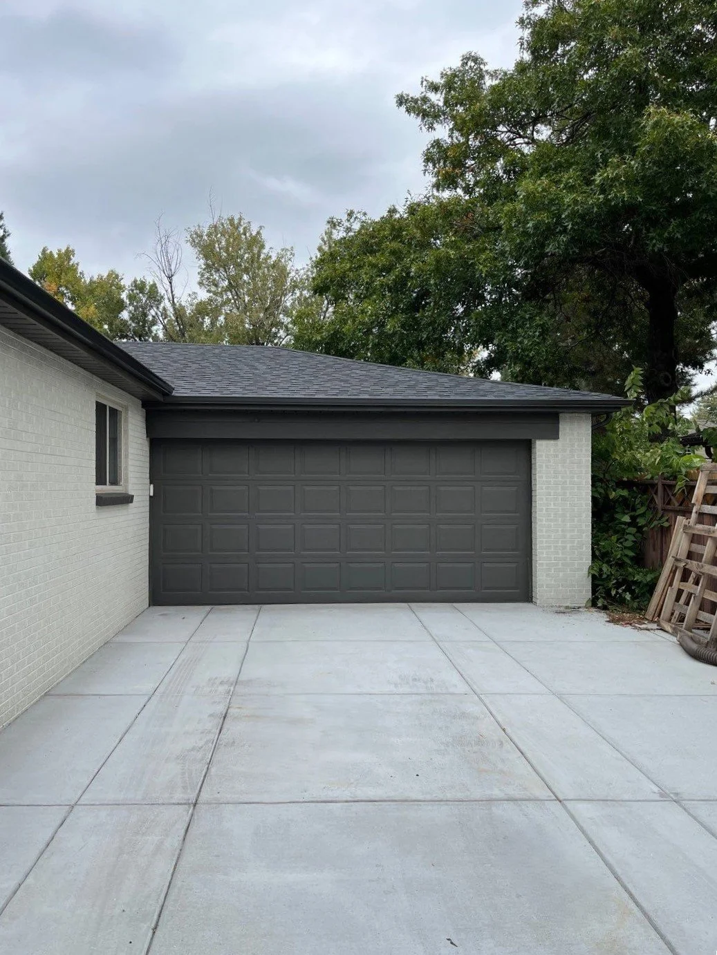 Full gutter replacement installed above the detached garage and along the adjoining roof edge.