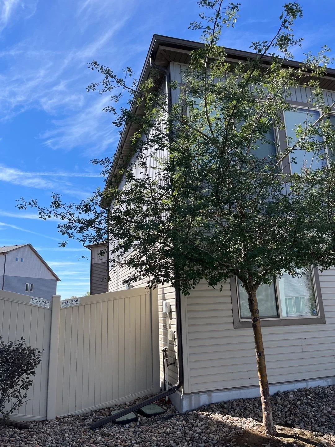 Seamless gutter installed along the side of a multi-story home.