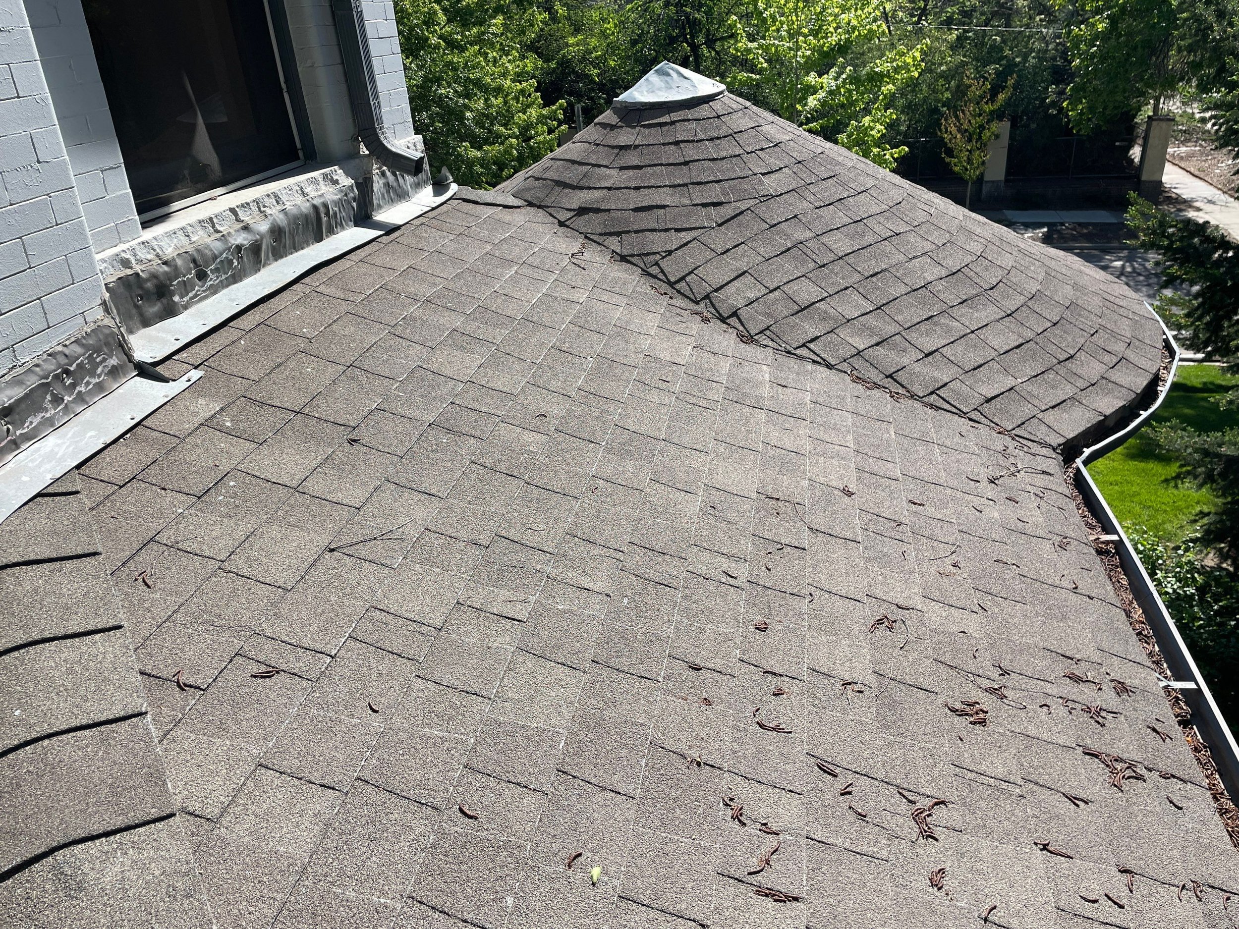 Old gutter system along an upper roofline before replacement.