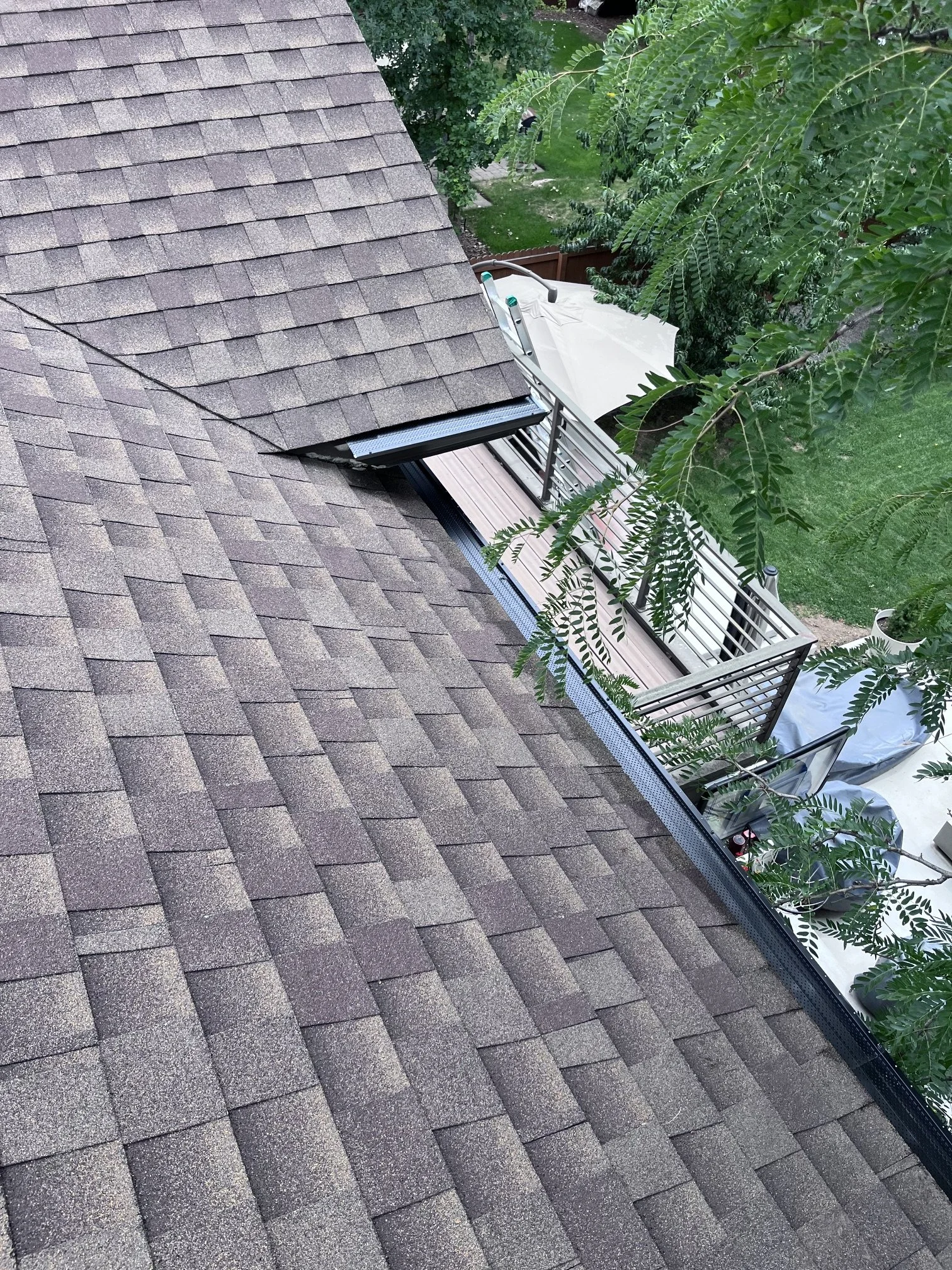 Real Gutter Covers installed on a Holly Hills home in Denver surrounded by mature trees.