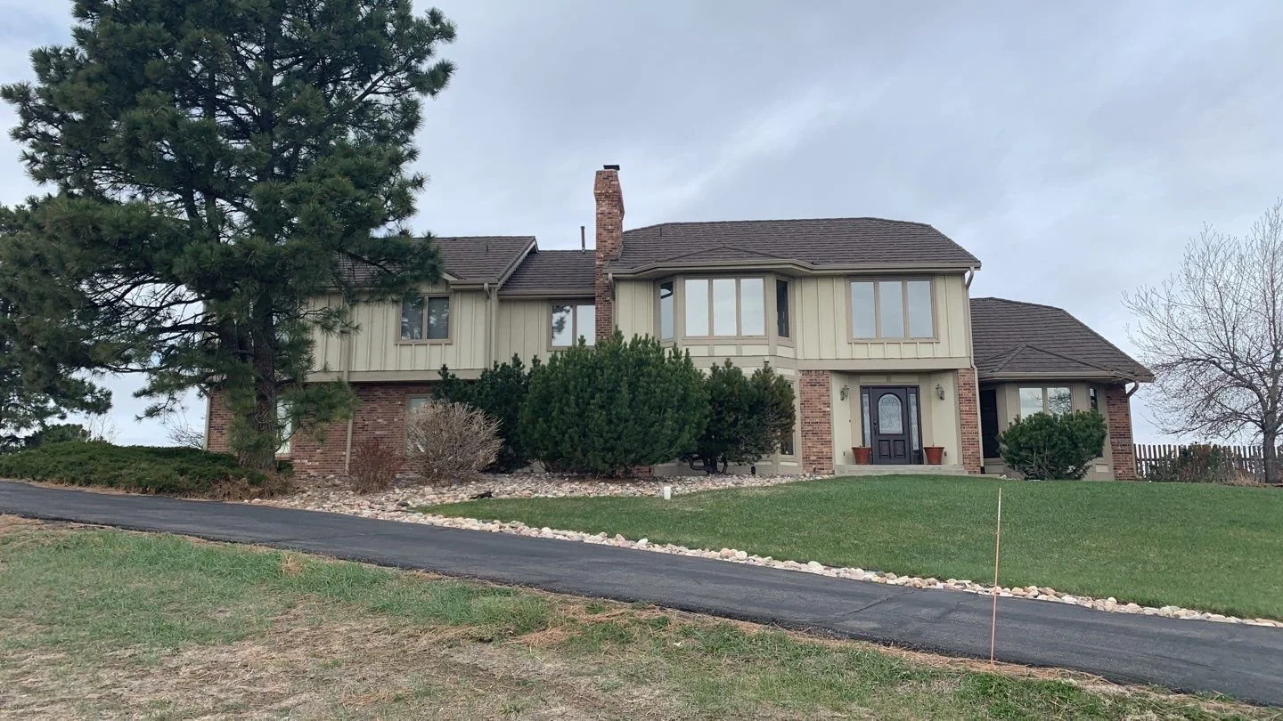 Two-story home with desert sand seamless gutters and downspouts in an established Denver Metro neighborhood.