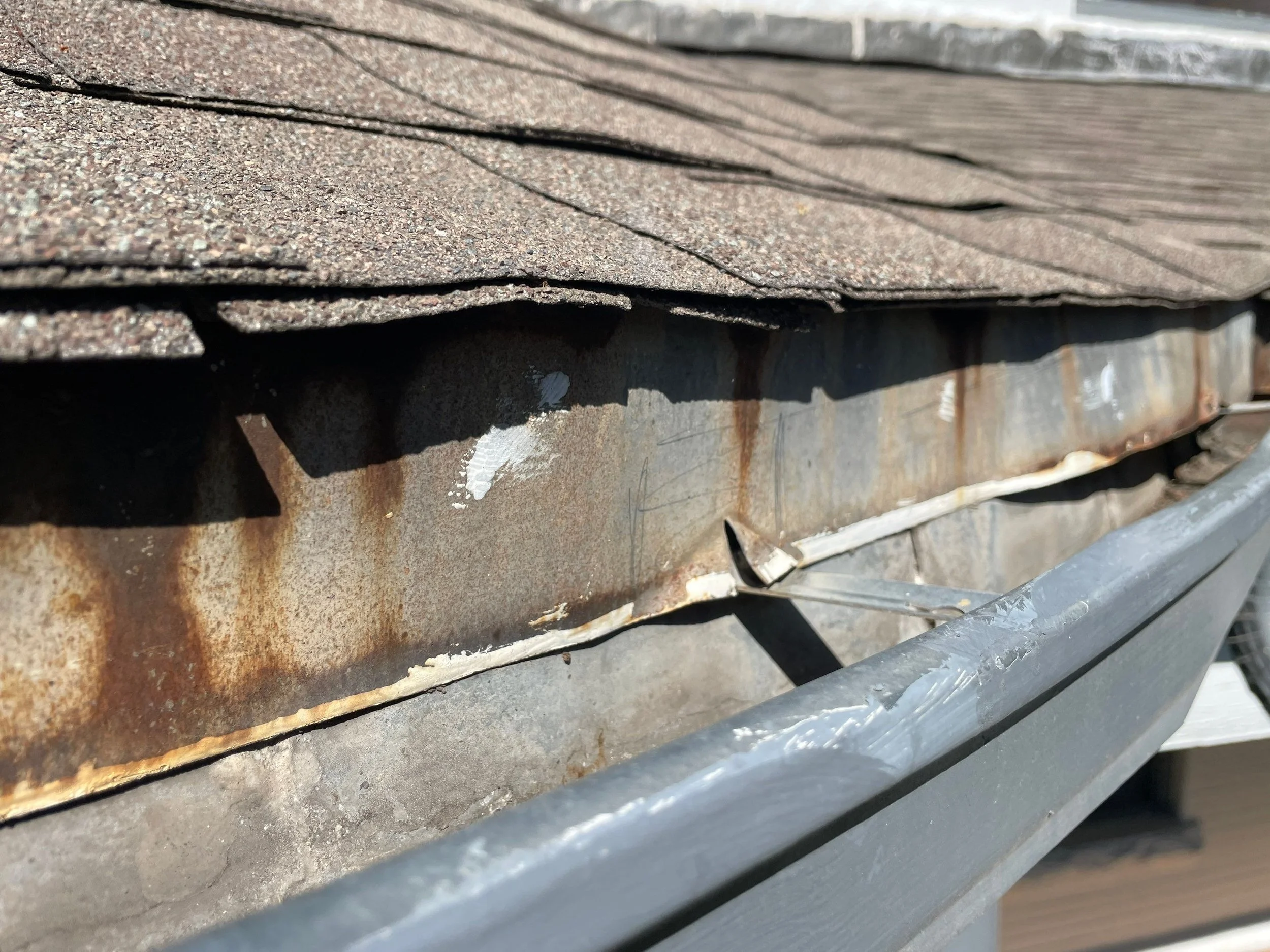Severely rusted and deteriorated gutter before replacement in Congress Park.