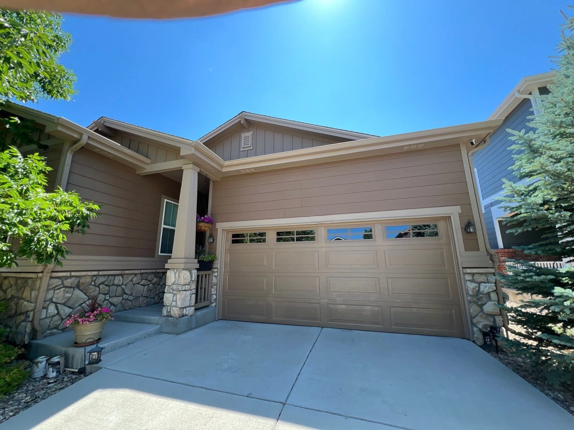 Seamless gutters were installed above the two-car garage, with downspouts positioned to carry water away from the driveway and foundation.