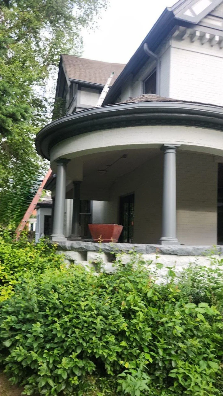 Rounded turret roofline requiring a custom-fitted gutter system.