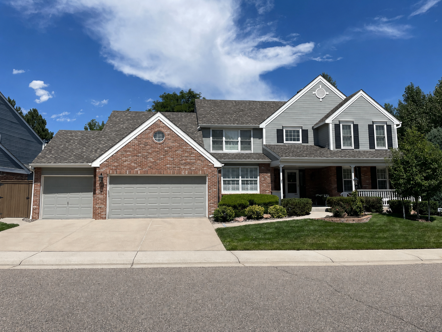 Complete gutter replacement installed across the front of a large two-story home with multiple rooflines.