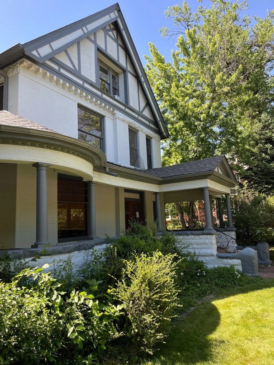 Completed charcoal gray gutter system across the front rooflines of the Congress Park home.