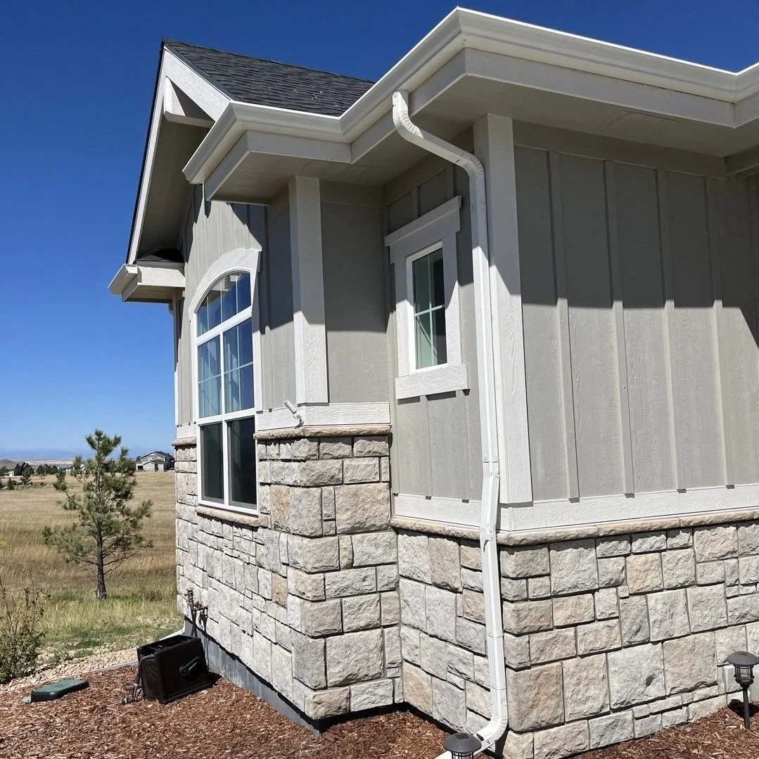 Covered side entry with a seamless gutter and downspout system.