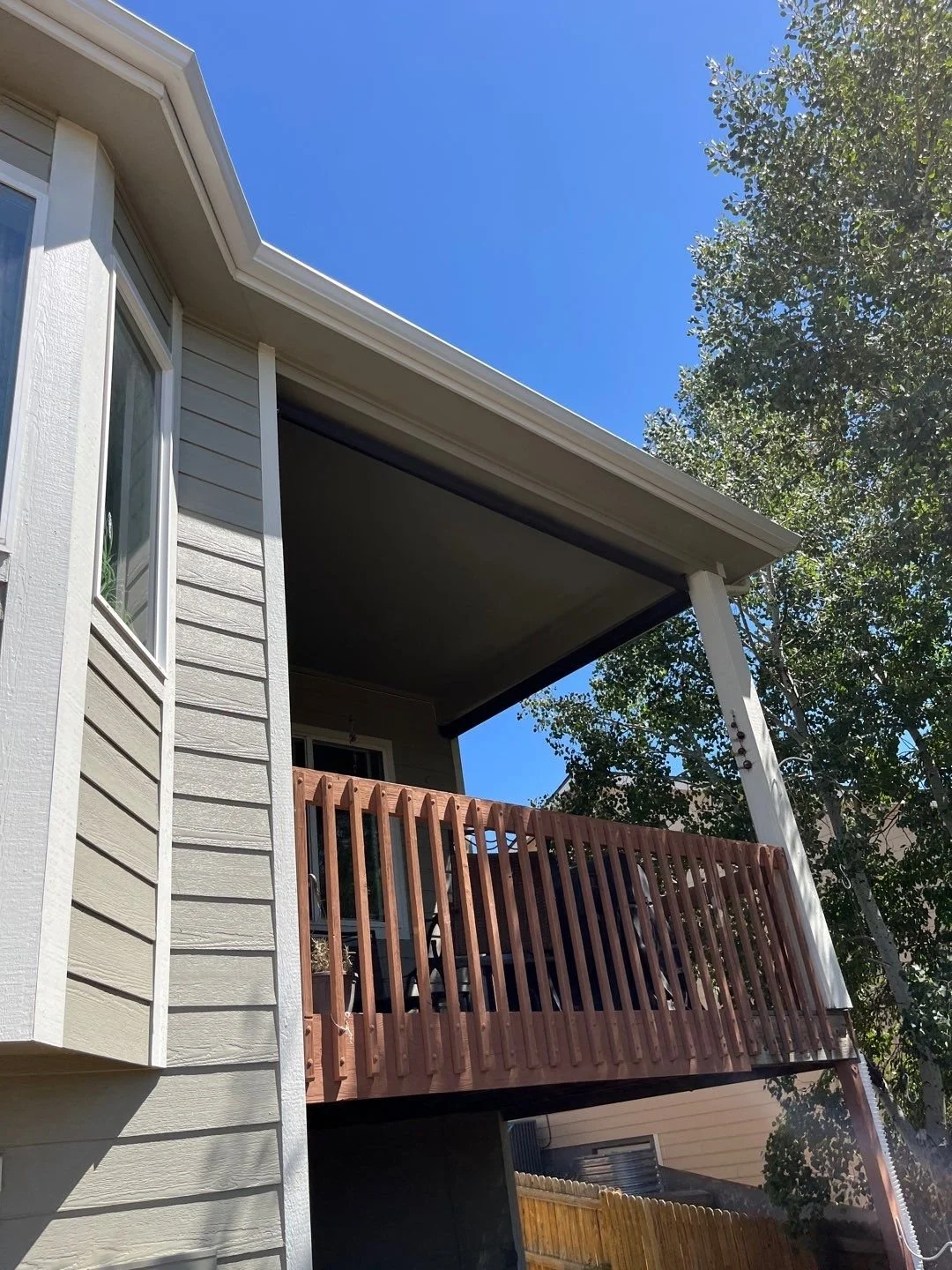 This covered side deck was fitted with a gutter and downspout system to manage runoff from the roof above.