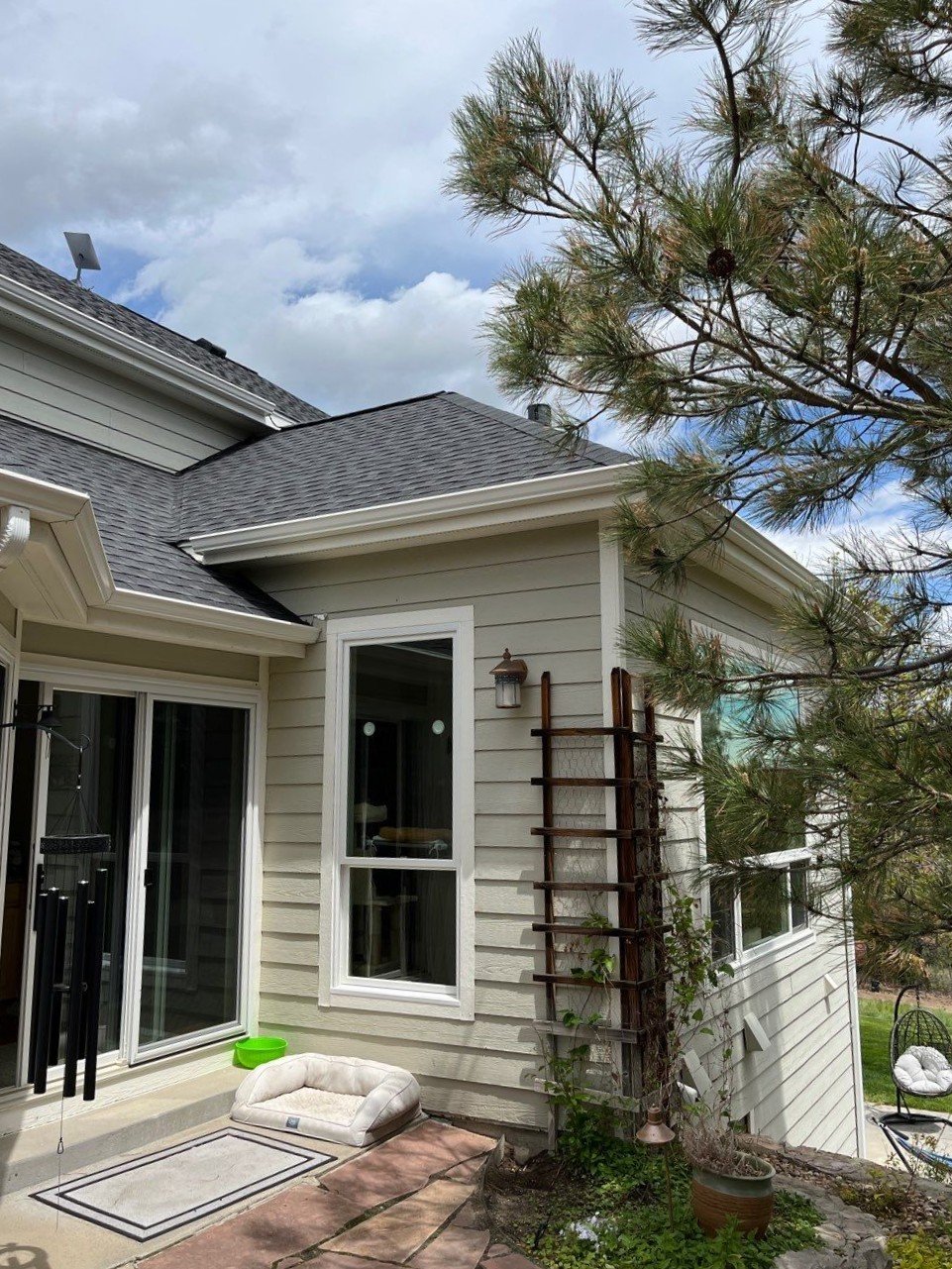 New white seamless gutter system installed along the angled rear rooflines of the Parker home.