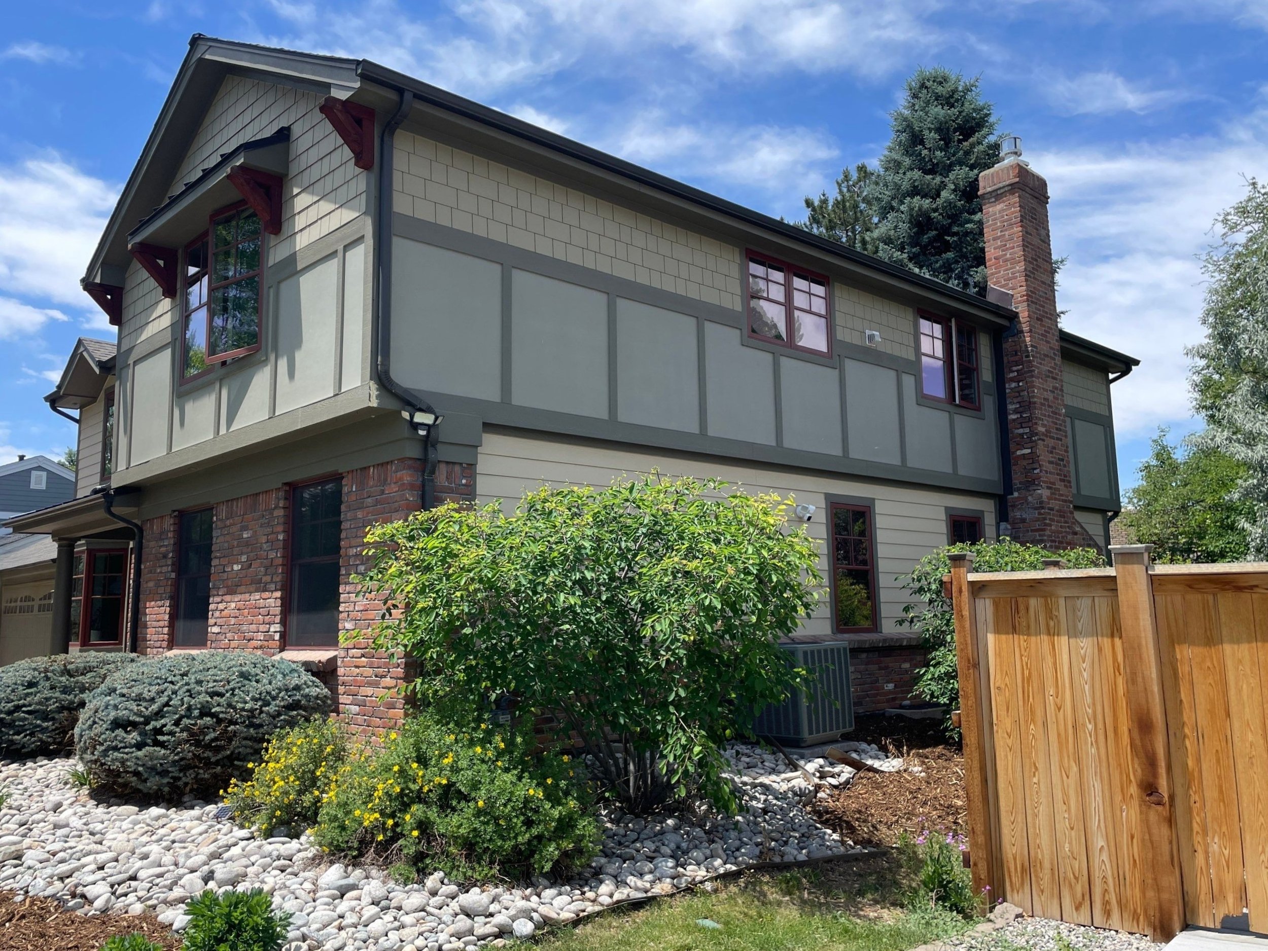 Residential gutter and downspout installation completed along the front and side rooflines.