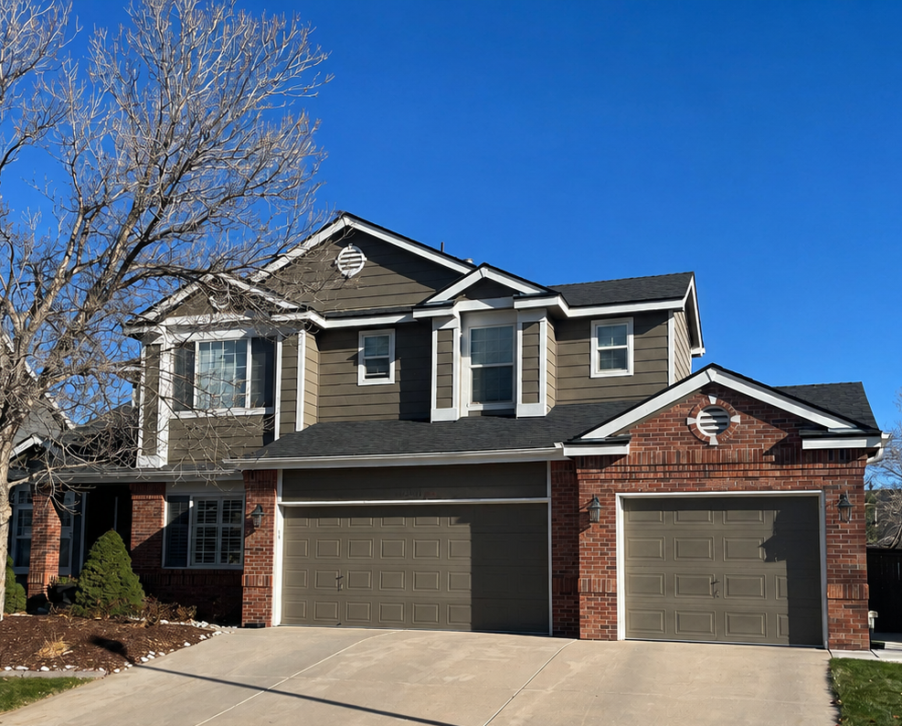 Full gutter and downspout replacement completed on a brick-and-siding home with an attached garage.