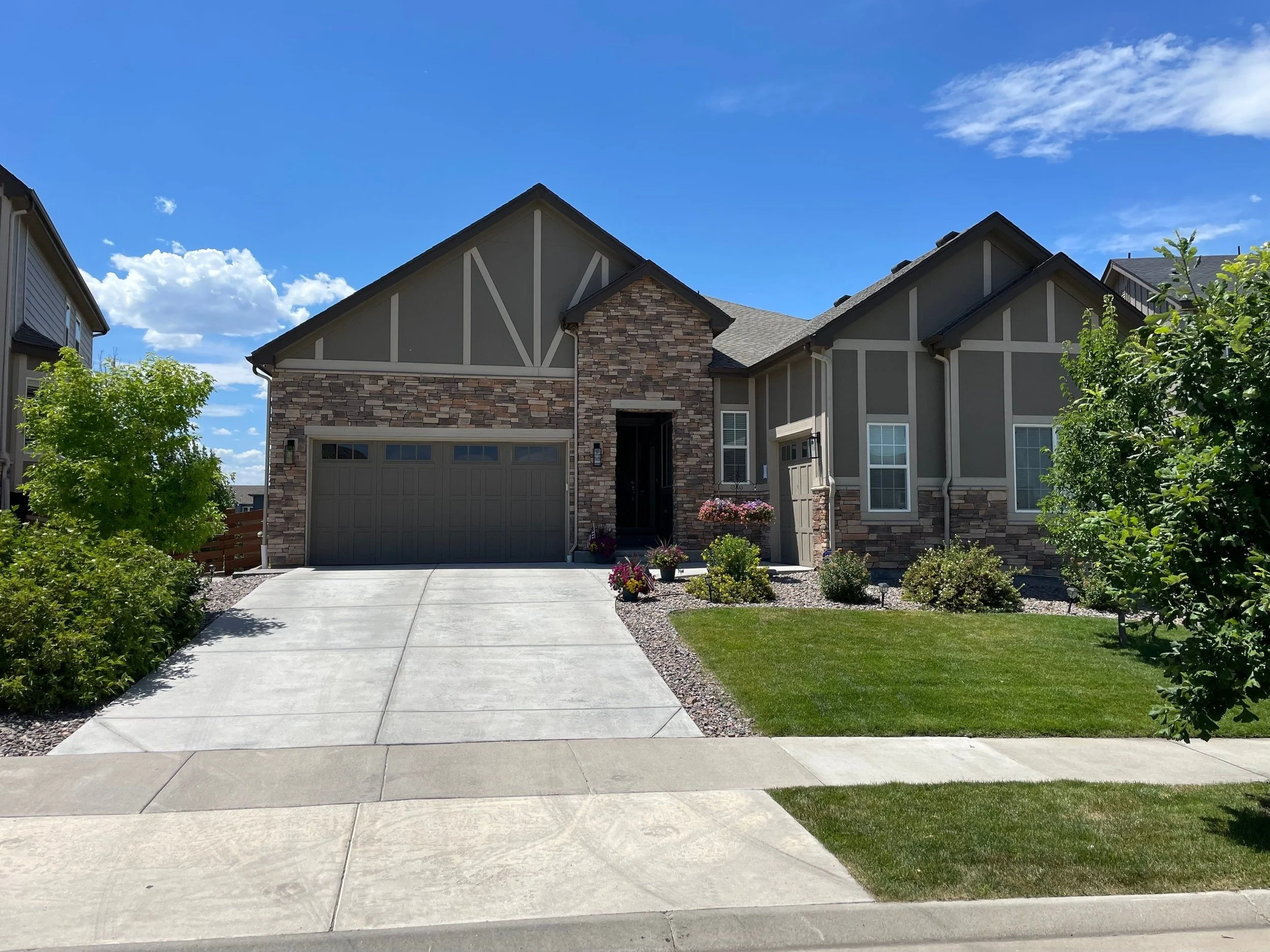 This large custom home features new gutters and downspouts designed around several intersecting rooflines.