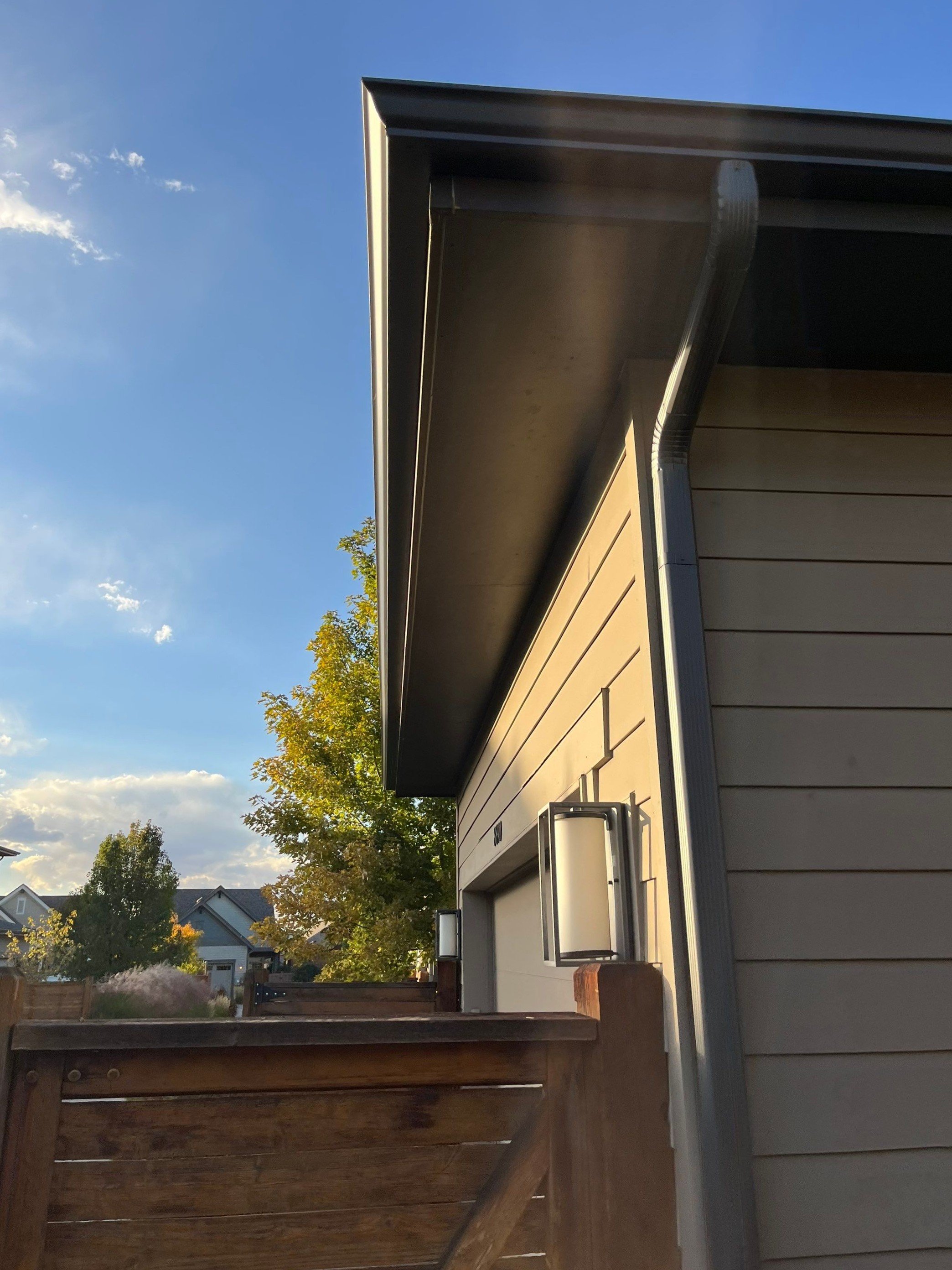 Close-up of a seamless gutter installed along a residential roofline.