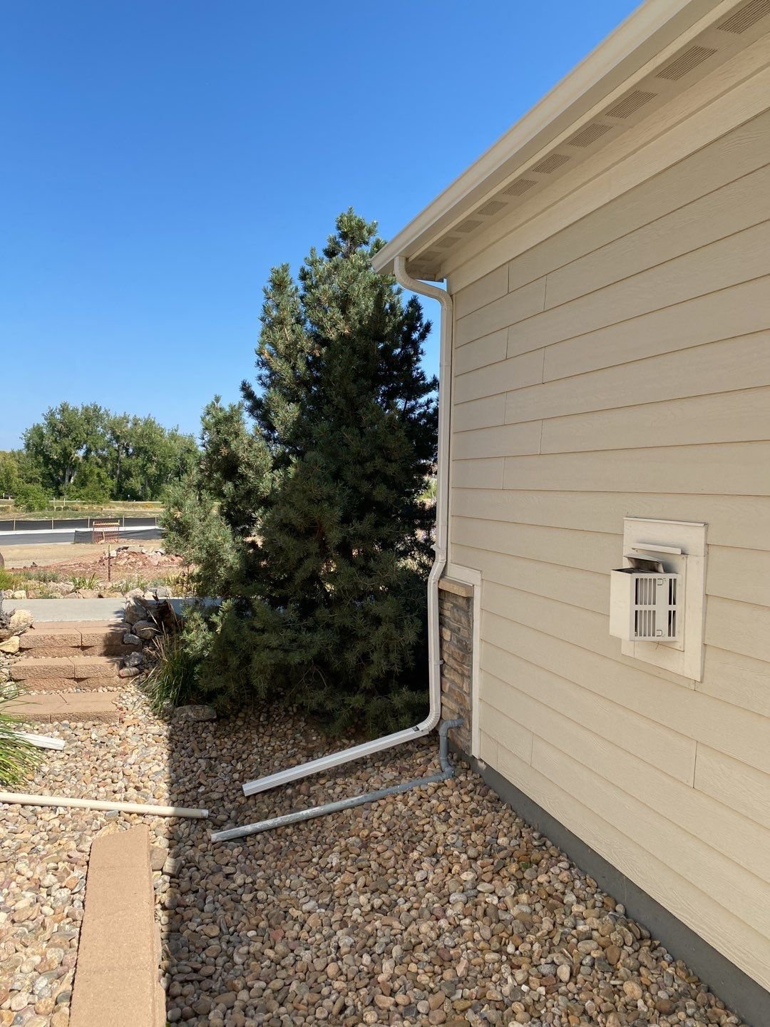 Seamless gutter installation designed to carry roof runoff away from the side yard and foundation.