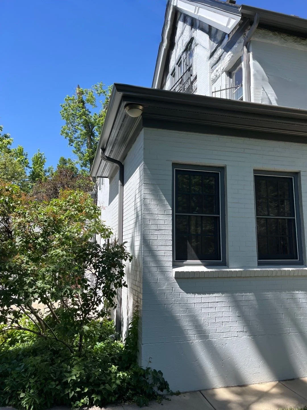New charcoal gray gutters and downspout installed on the back mudroom of a Congress Park home in Denver.