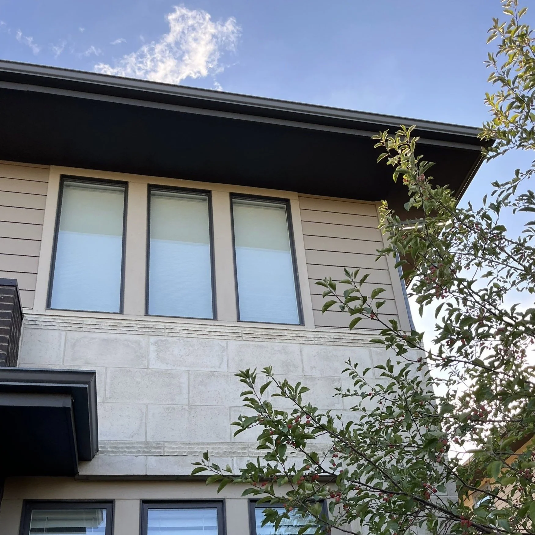Close-up of a seamless gutter installed beneath an upper-story roofline.