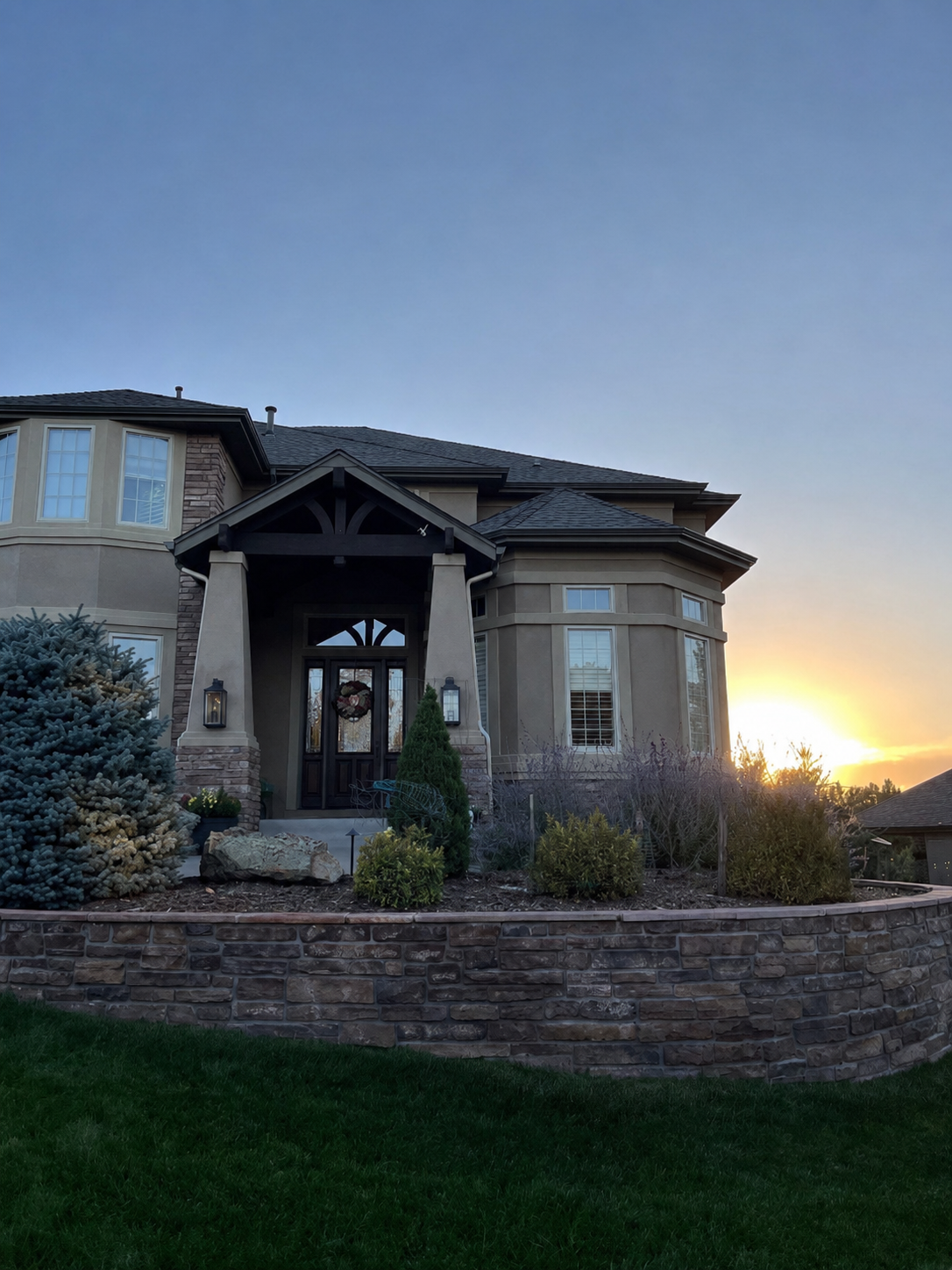 New seamless gutters installed around the entry roof and main roofline of a custom home.
