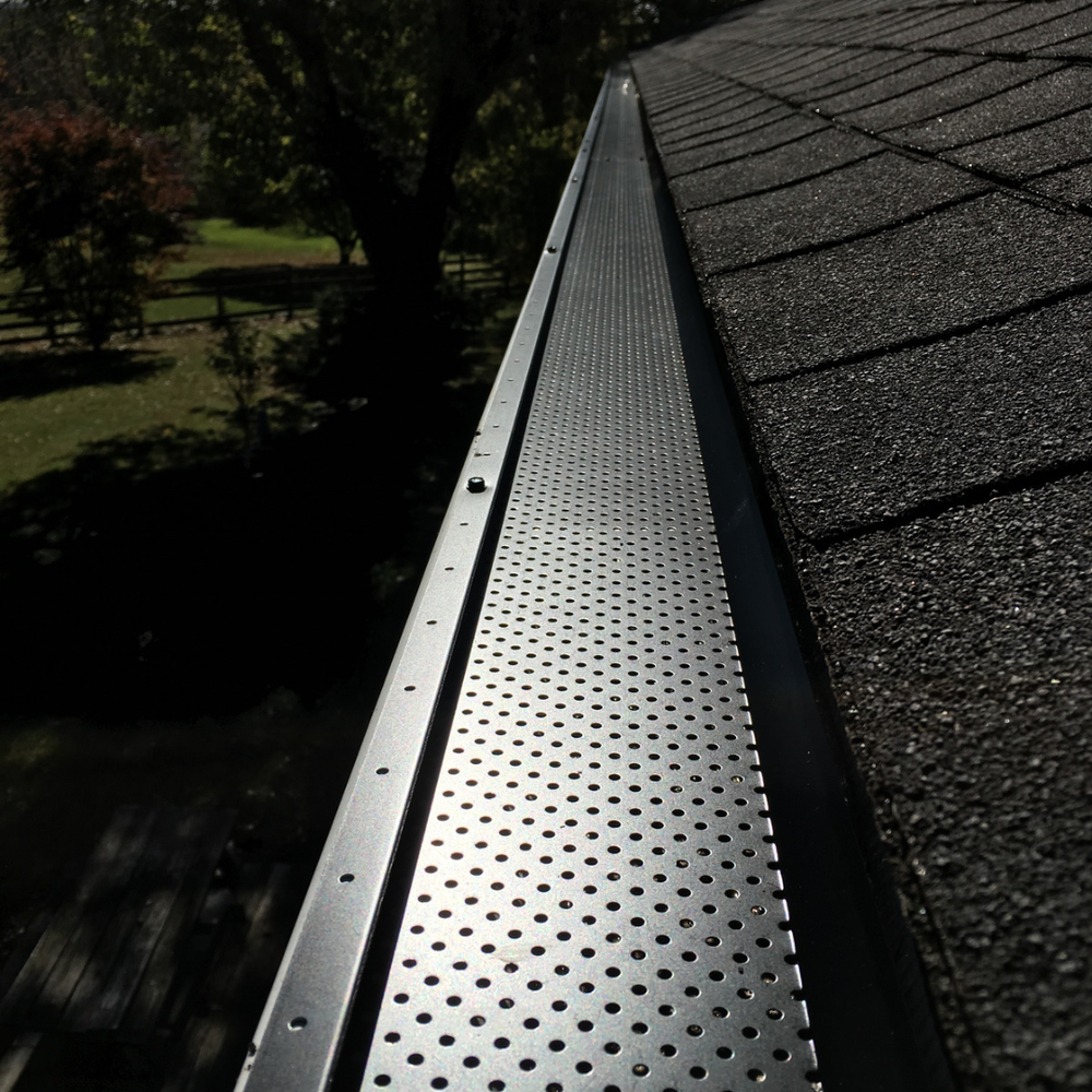 Gutter guard installation completed over a seamless gutter system.
