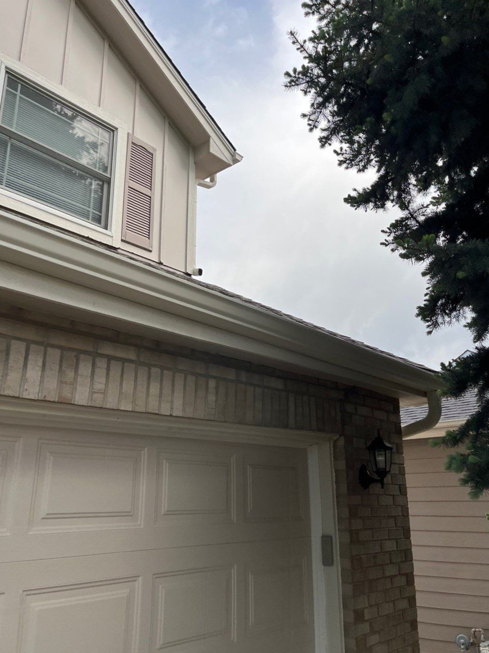 Gutter and downspout replacement completed above the garage and along the side roofline.