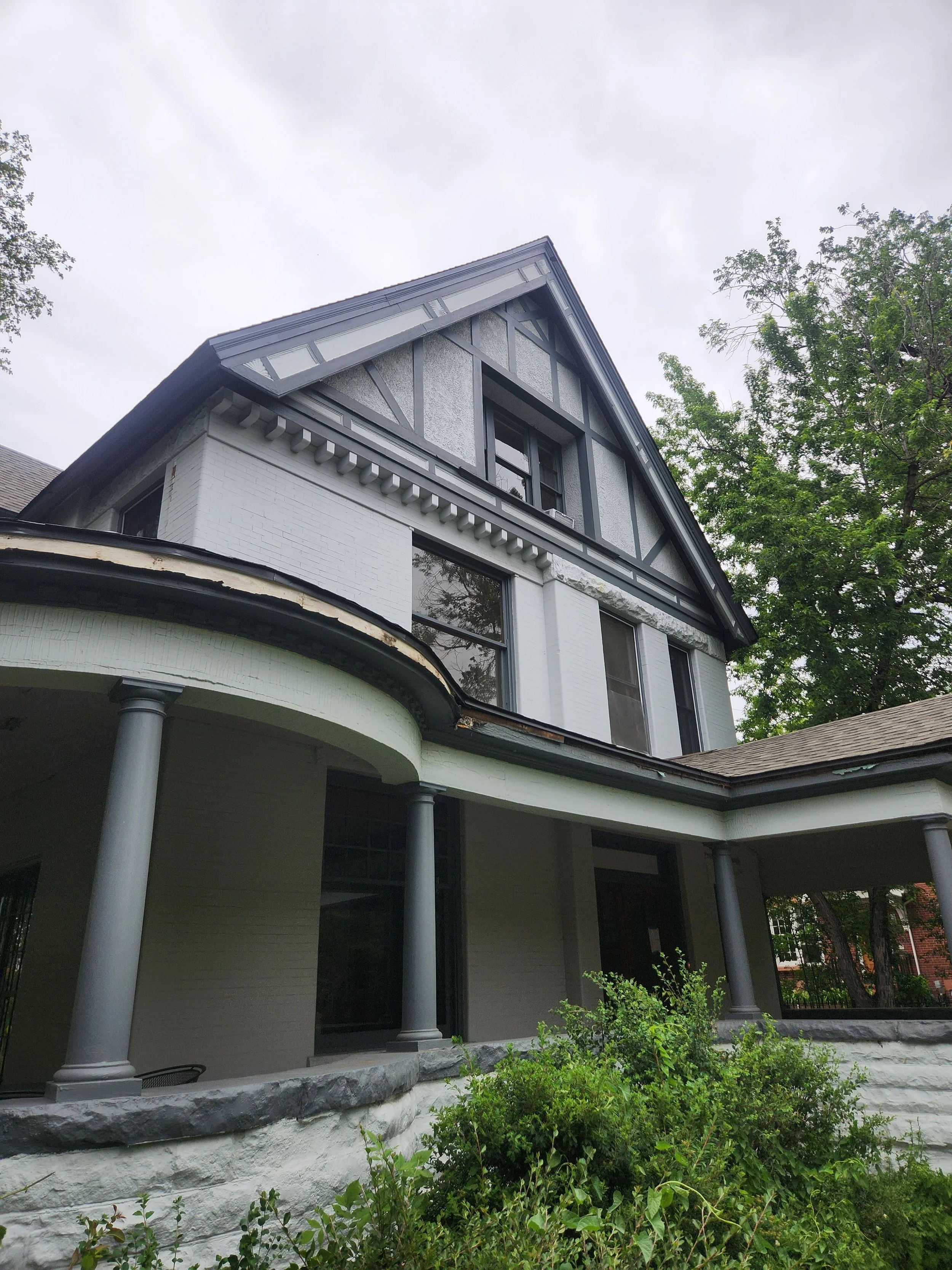 Charcoal gray gutters installed to coordinate with the trim of the Congress Park home.