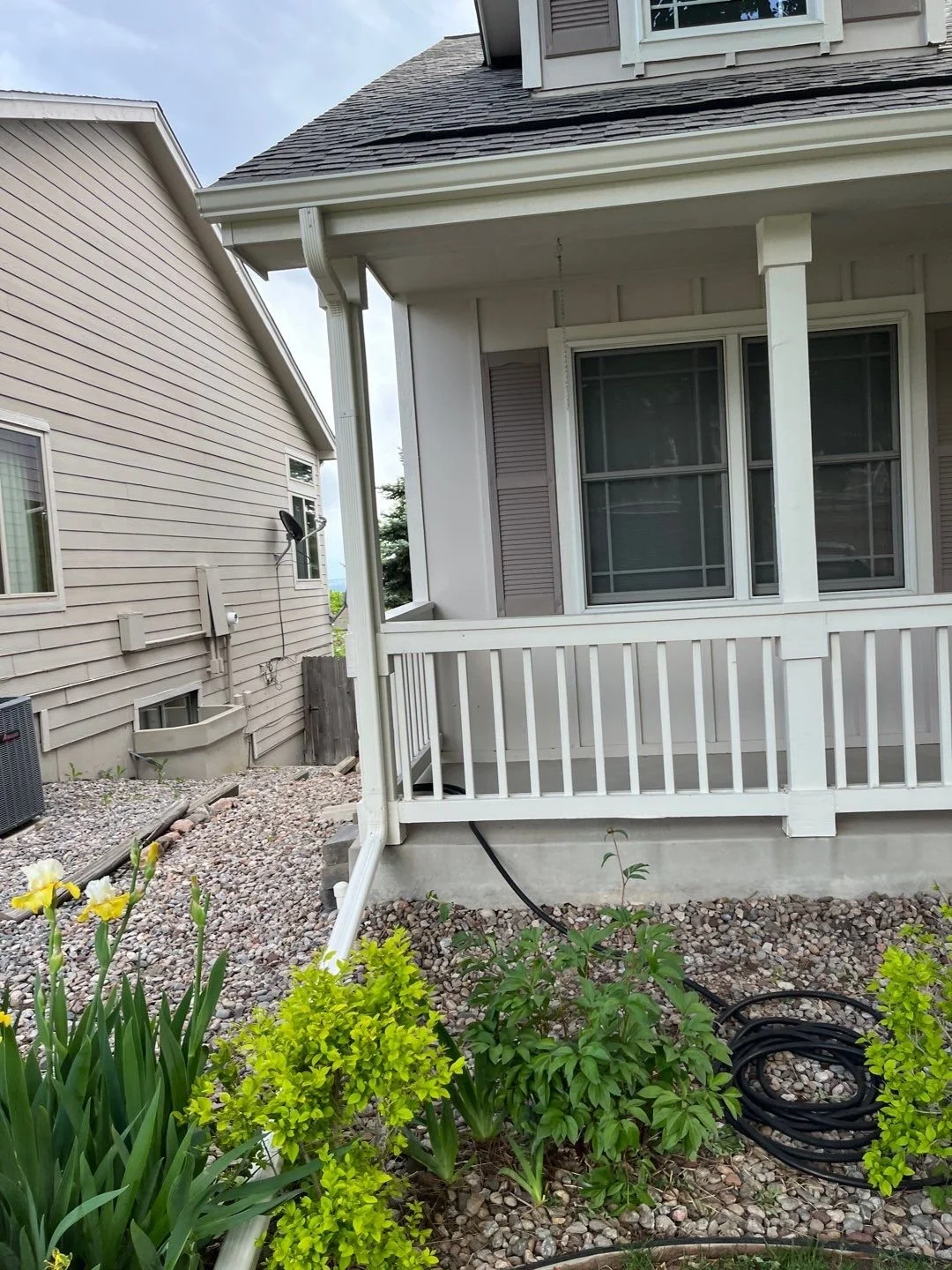 Completed front porch gutter and downspout installation coordinated with the trim of a Green Mountain, Lakewood home.