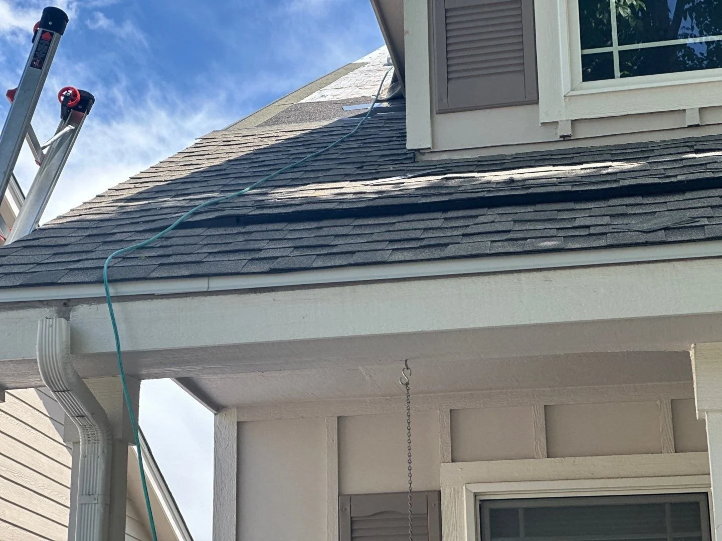 New shingle roof and exposed fascia after the old gutters were removed during roof replacement in Lakewood.