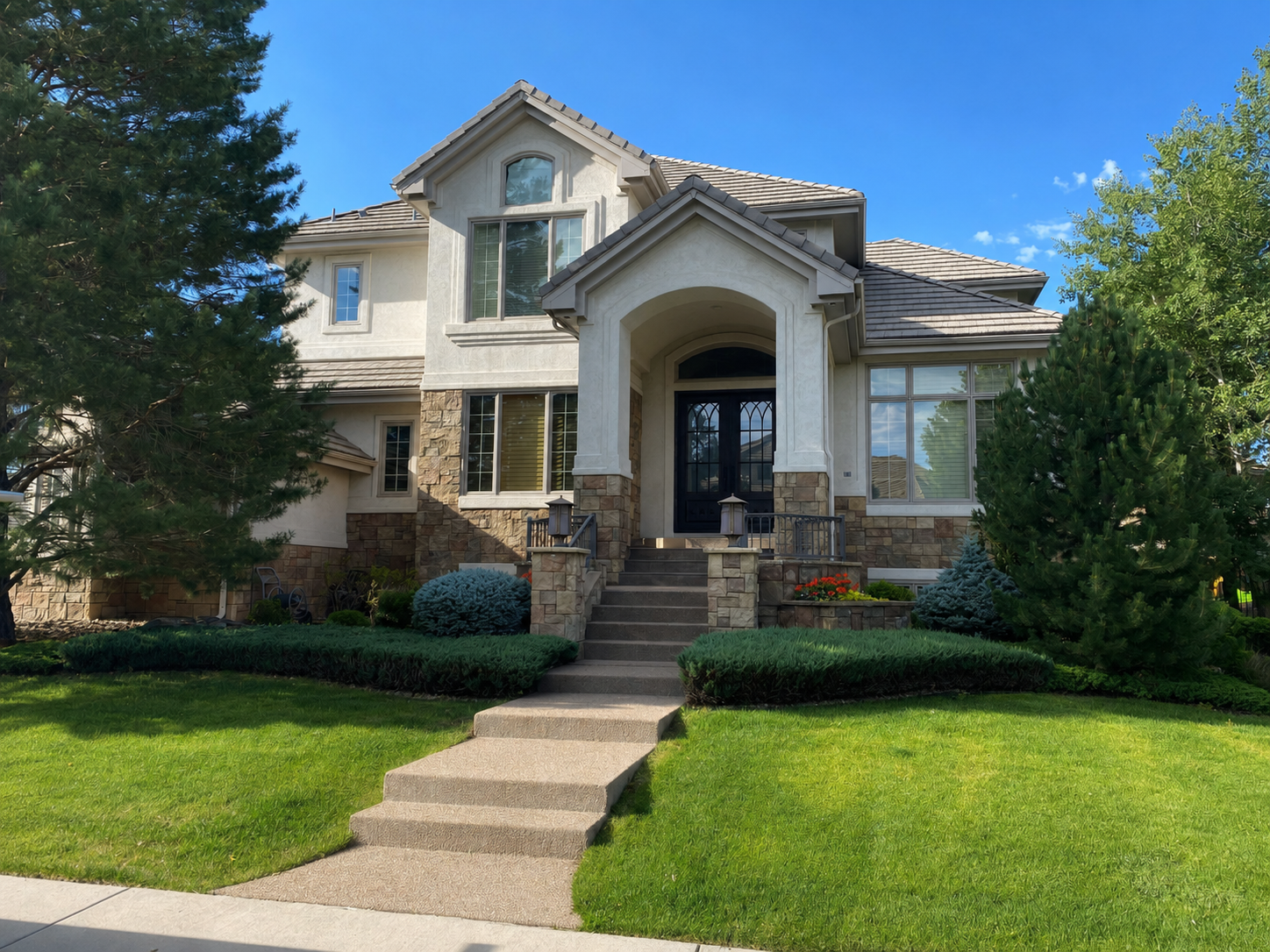 New gutter installation completed around the covered entry and upper roof sections of a multi-story home.