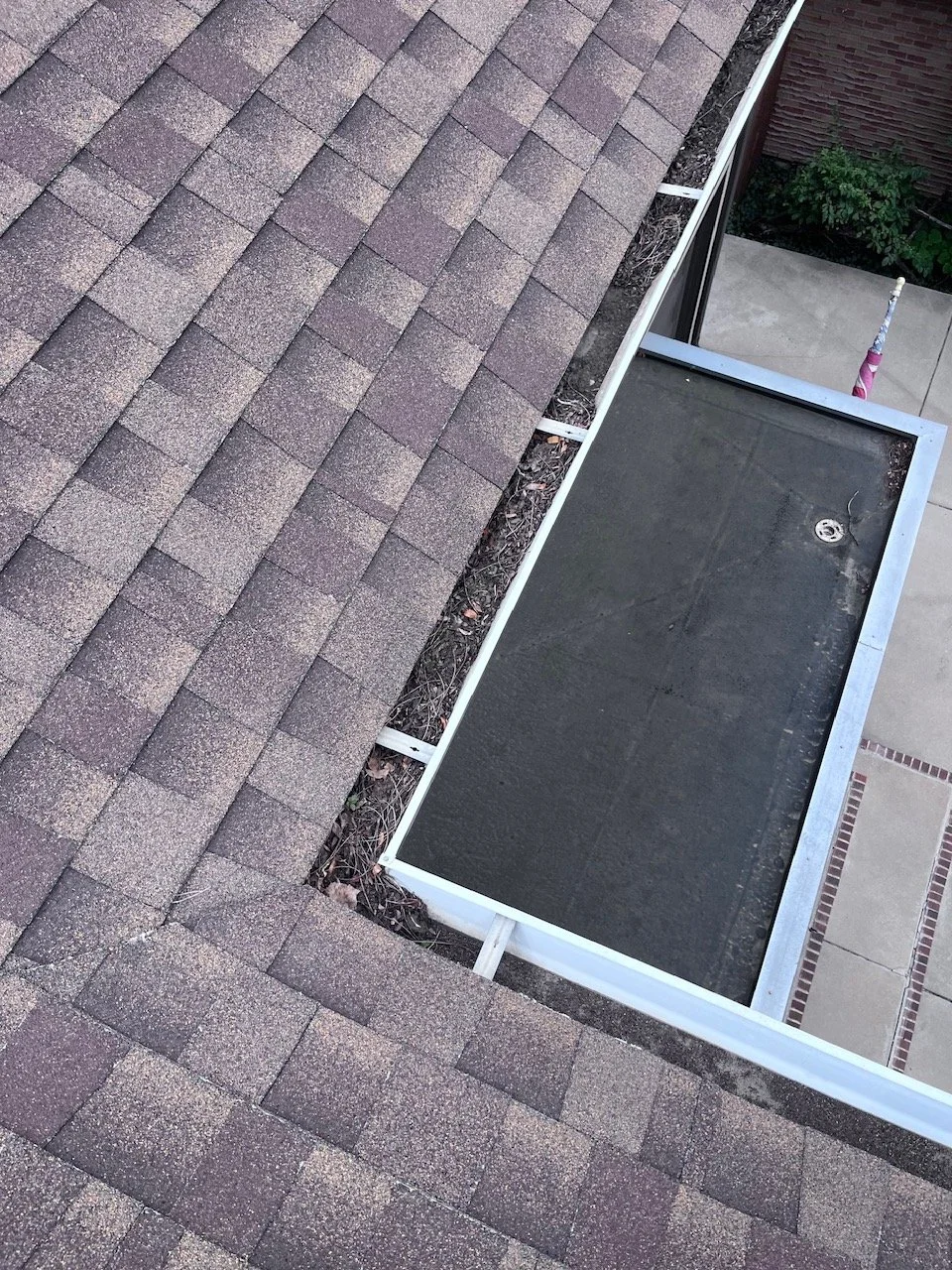 Heavy leaf buildup restricting drainage inside a Denver home’s gutter system.