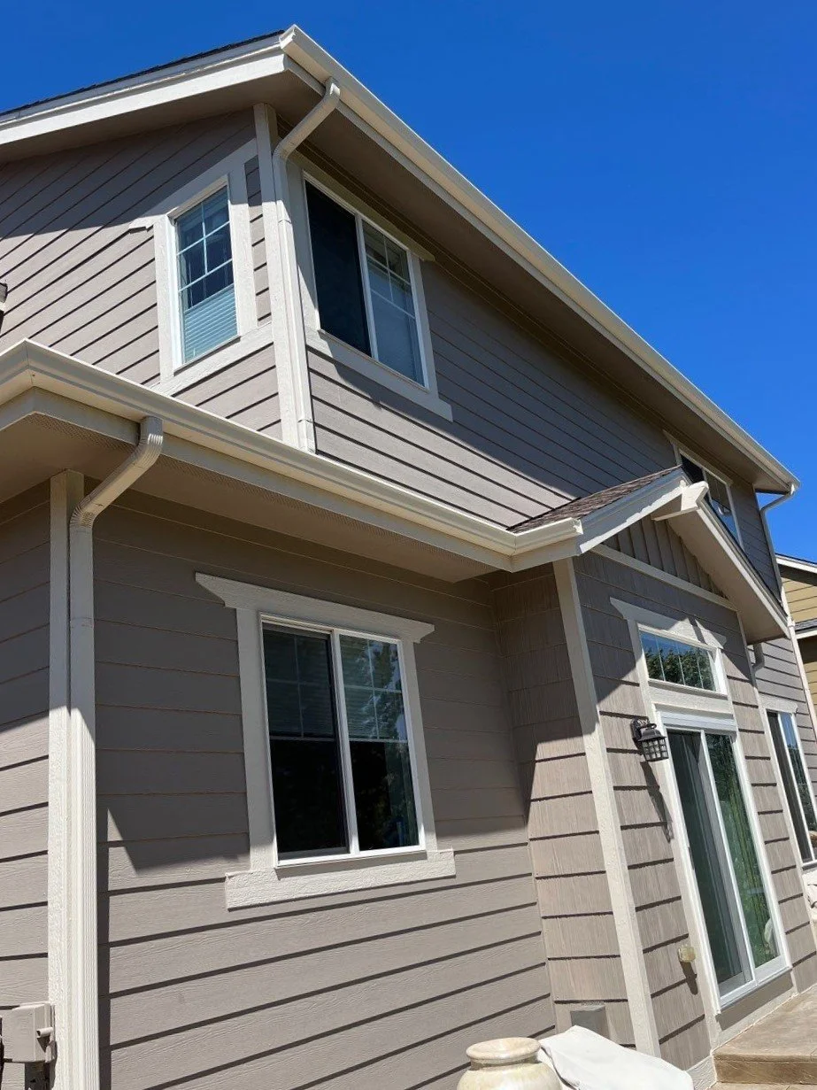 The home’s front roofline was updated with seamless gutters and matching downspouts for a cleaner, more finished appearance.
