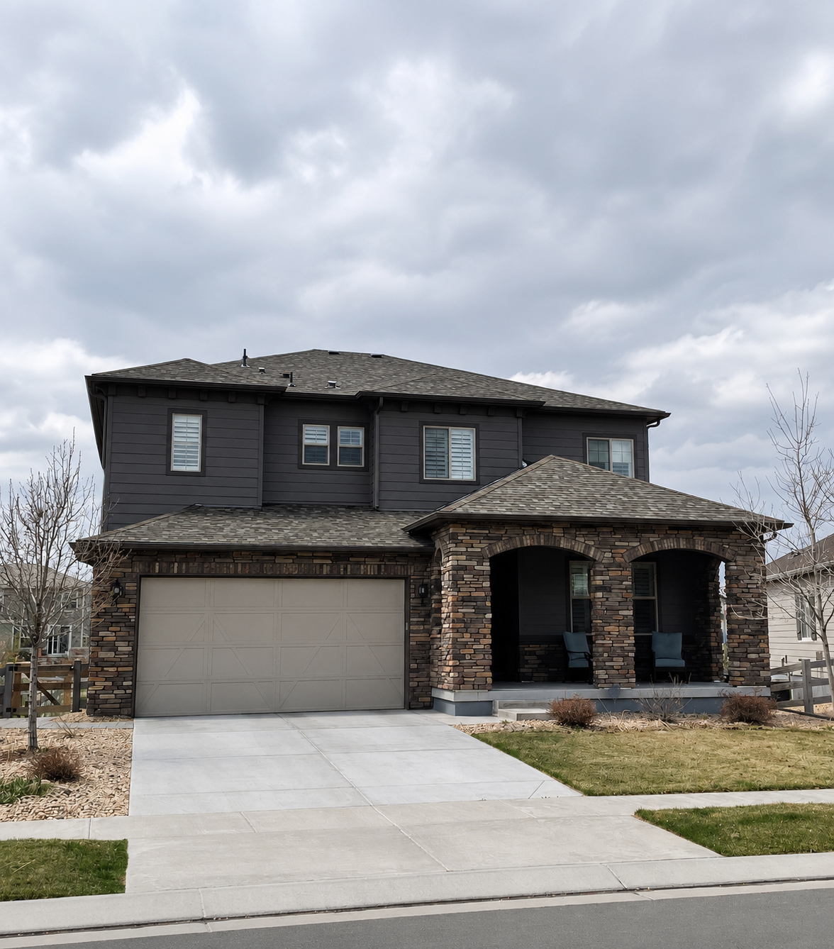 Modern two-story home with dark seamless gutters and an attached garage in the Denver Metro area.