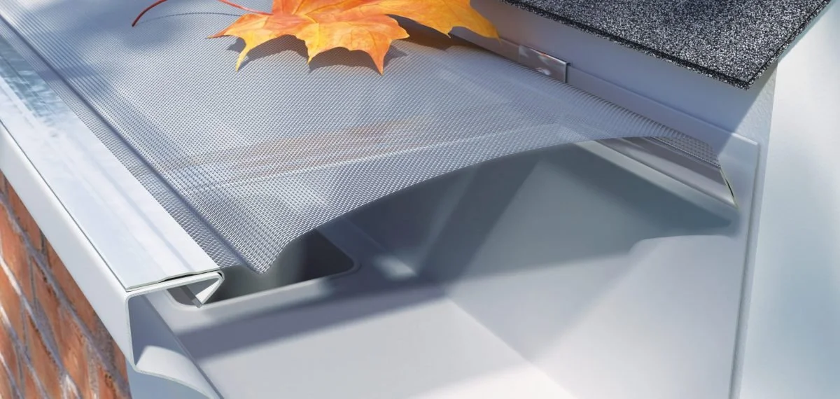 Cutaway illustration of the EZ Leaf Destroyer micro-mesh gutter guard installed beneath roof shingles and over the gutter.