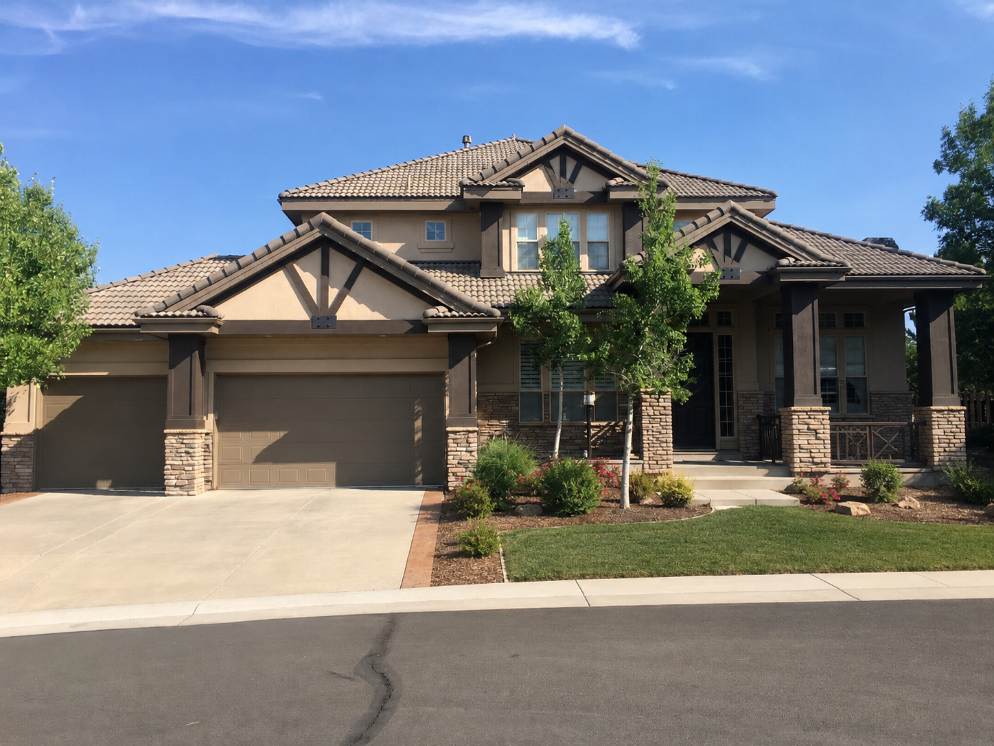 Custom seamless gutters and downspouts installed around the complex rooflines of a large residential property.